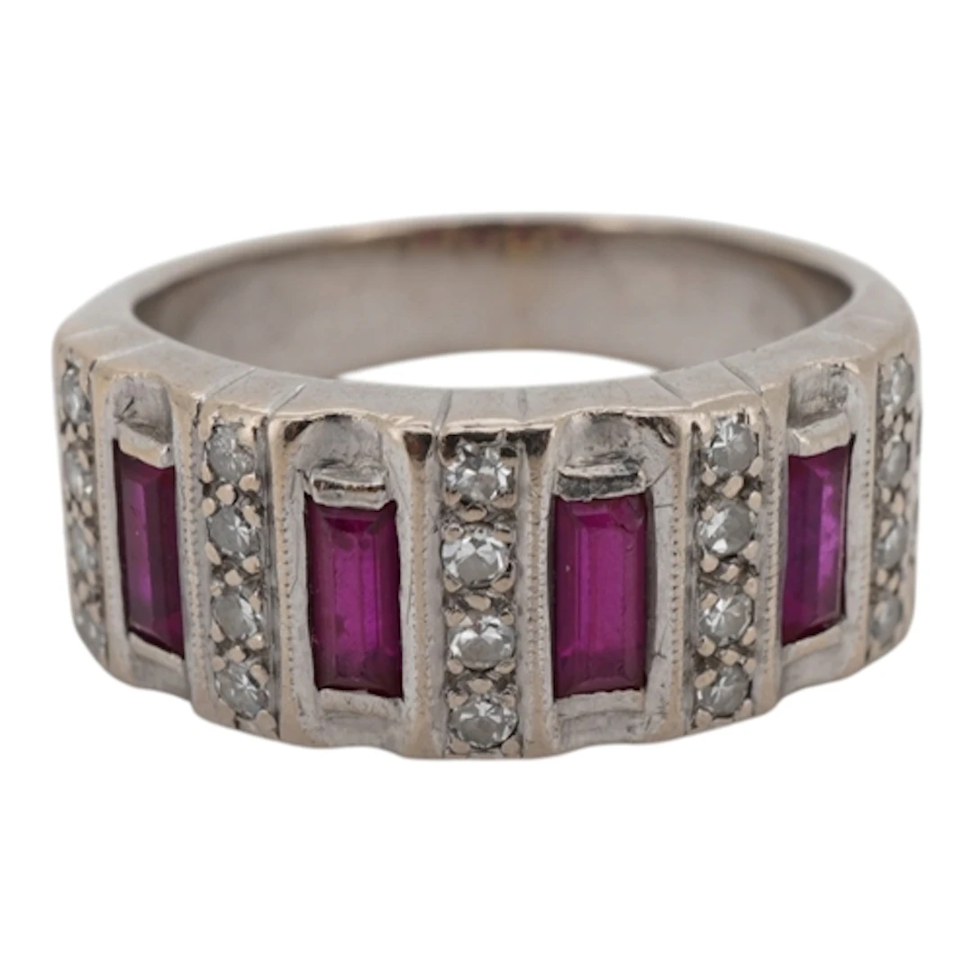 A white metal and four stone baguette ruby set ring with bor...