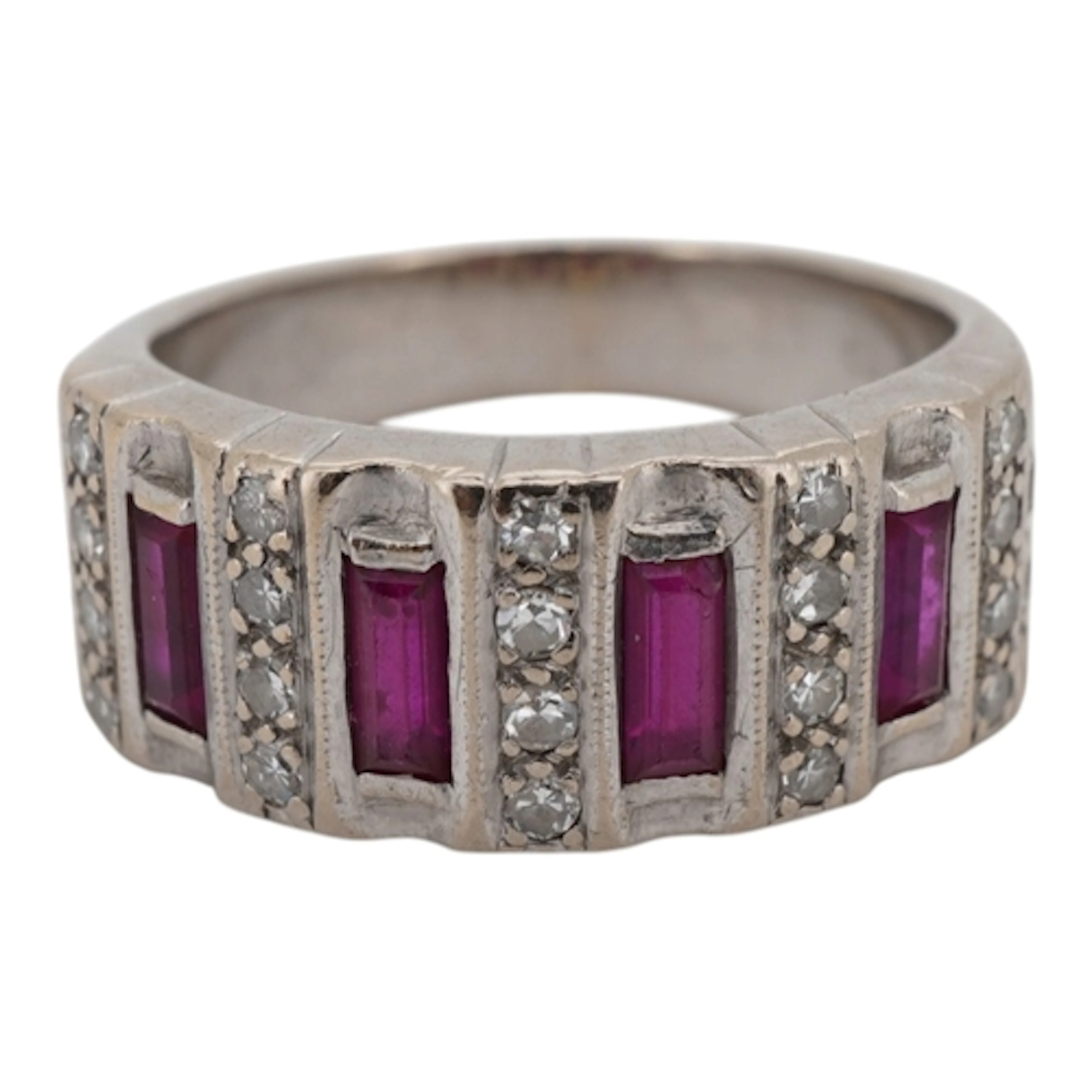 A white metal and four stone baguette ruby set ring with bor...