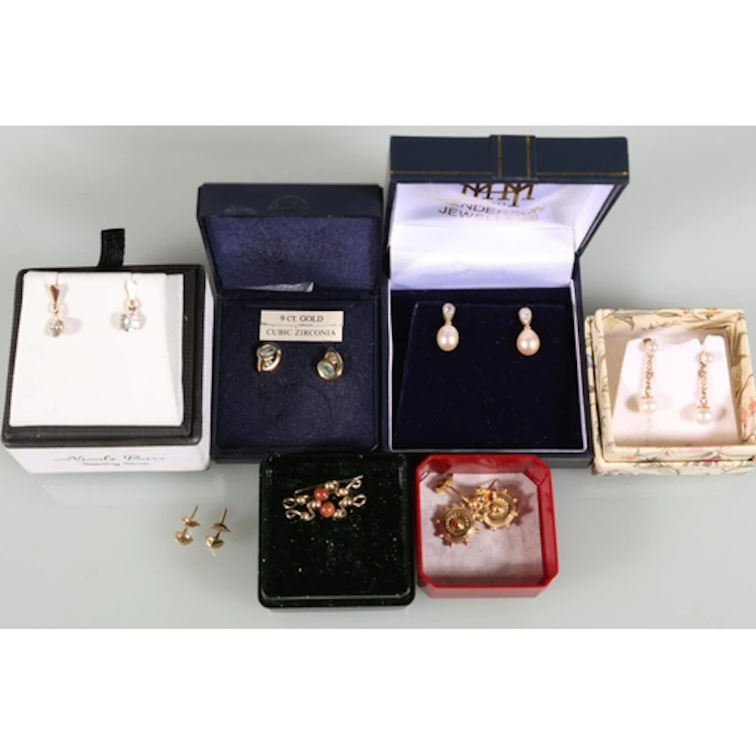 Pair of gold tone and pearl earrings with butterflies stampe...