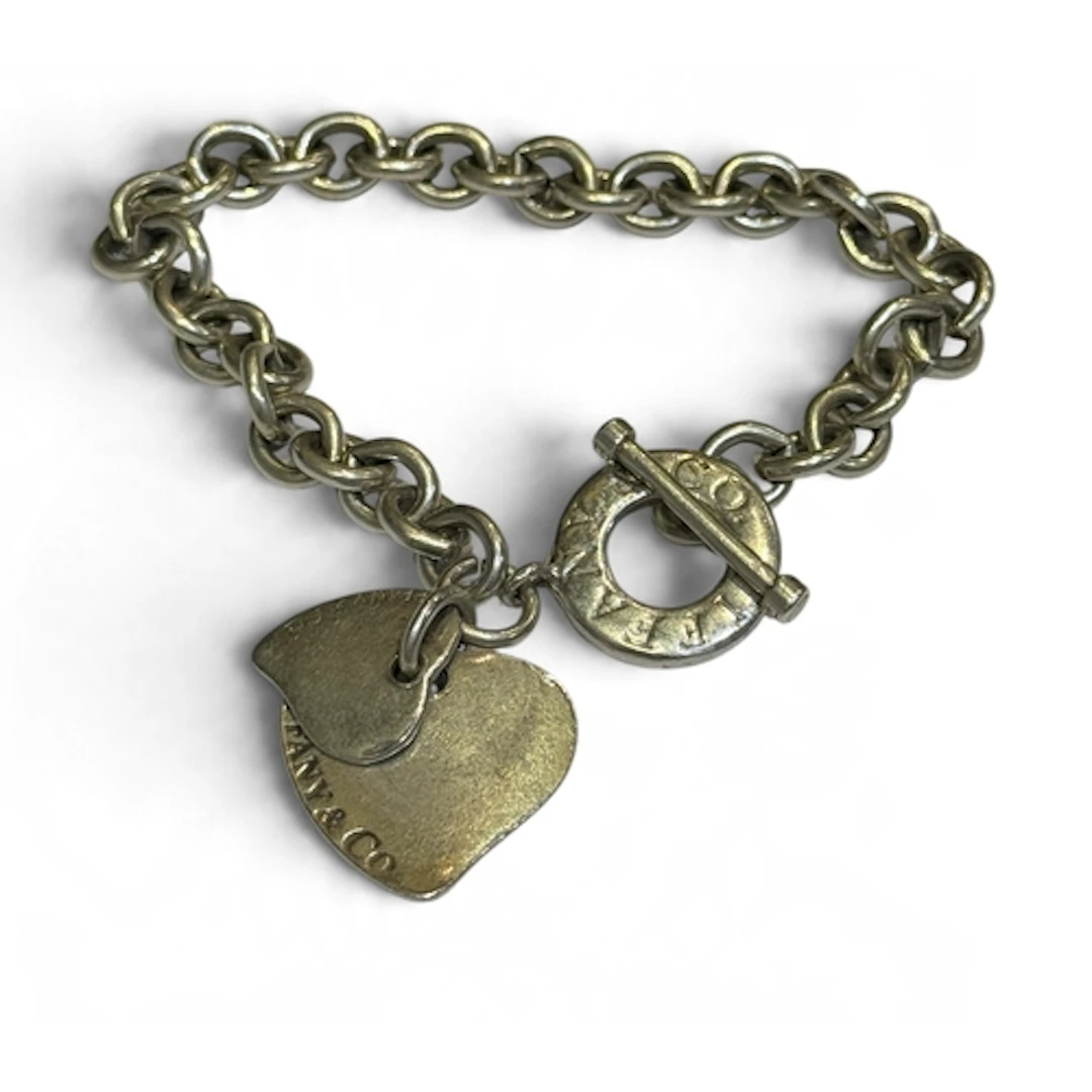 TIFFANY & CO: A SILVER CIRCULAR LINK BRACELET WITH HEART...