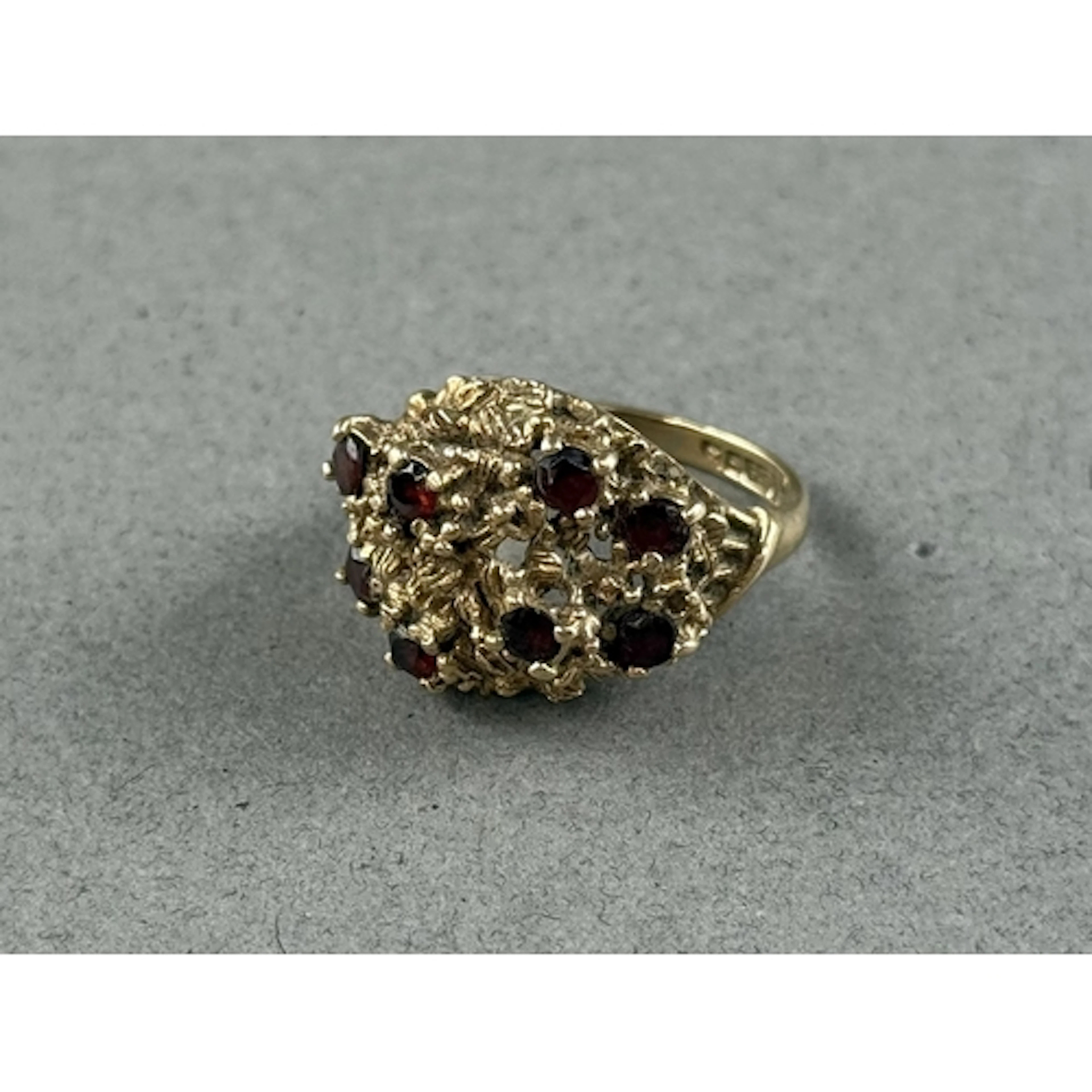 Jewellery: a 9ct yellow gold brutalist ring of pierced rockw...