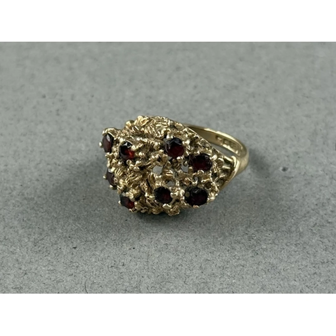 Jewellery: a 9ct yellow gold brutalist ring of pierced rockw...
