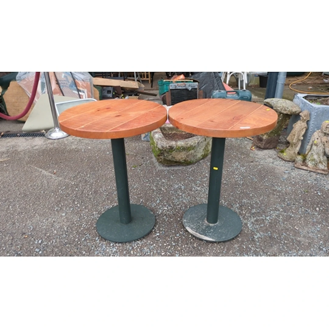A pair of contemporary bistro tables, each with a circular p...