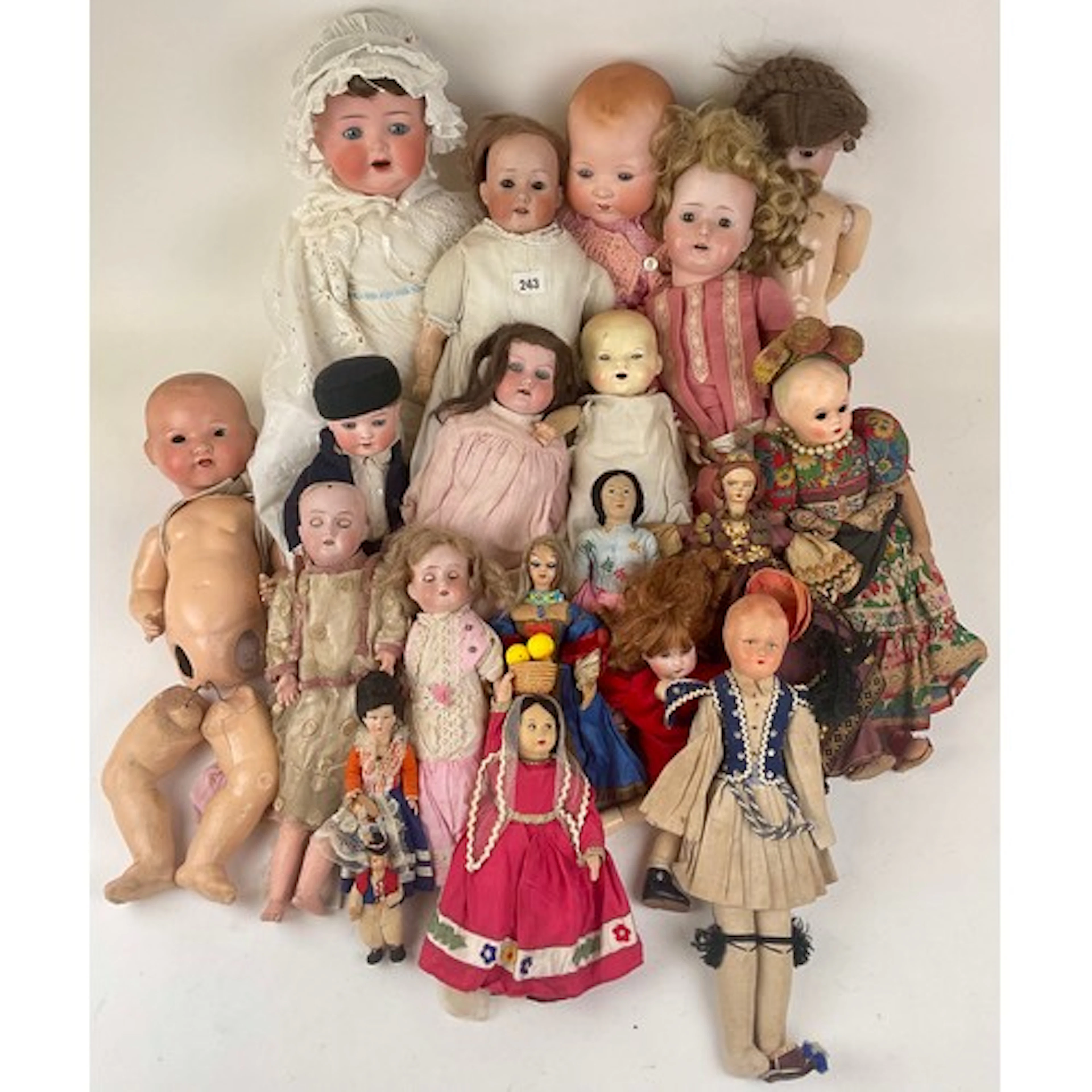 Dolls - An early 20th century bisque headed, soft bodied dol...