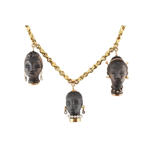 A blackamoor pendant 18ct gold necklace. The three Nubian fe...