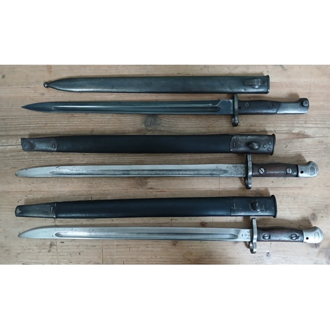 A group of three 1907 Lee Enfield bayonets and scabbards.