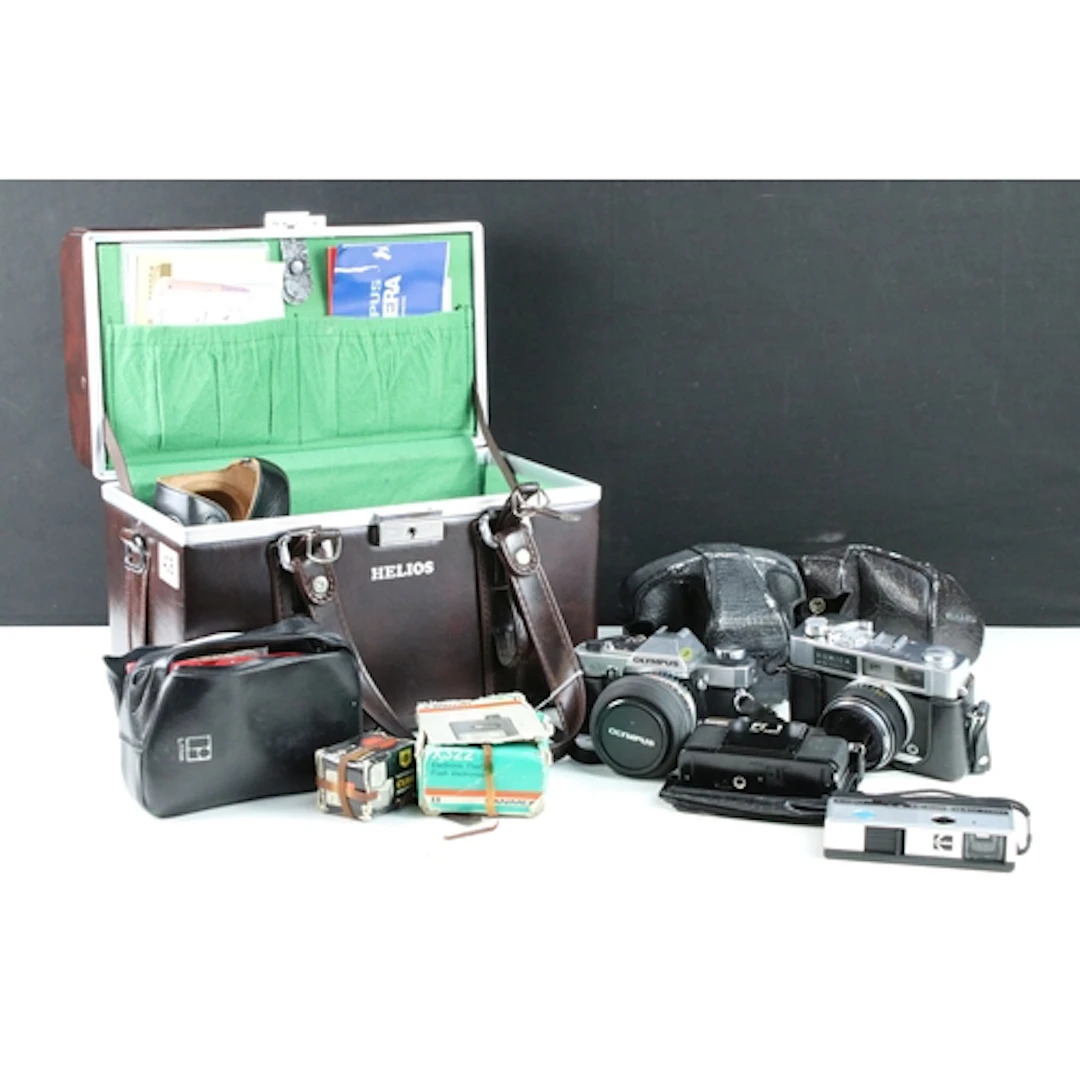 Olympus OM20 SLR camera, a Konica EE-Matic Deluxe camera and...