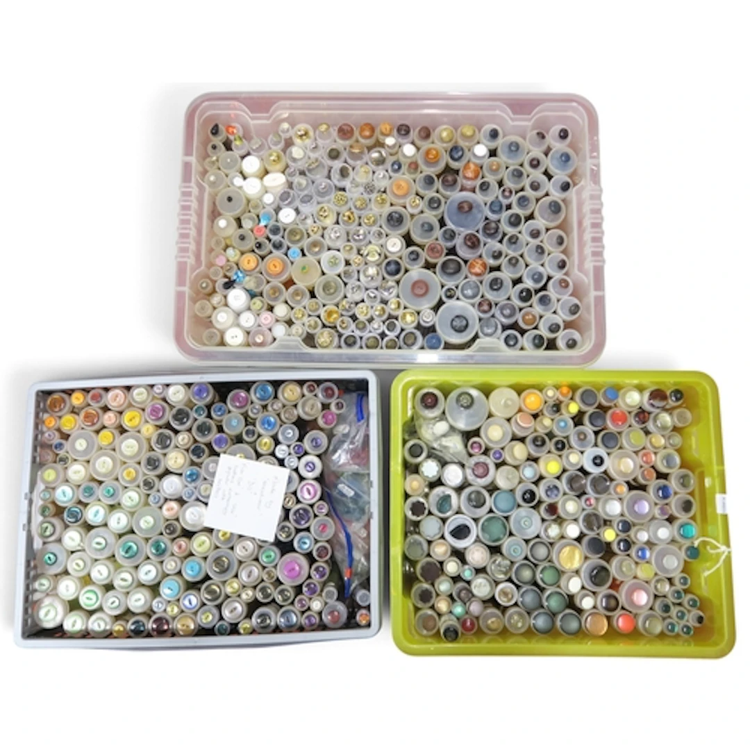 A large collection of buttons to include leather, faux pearl...