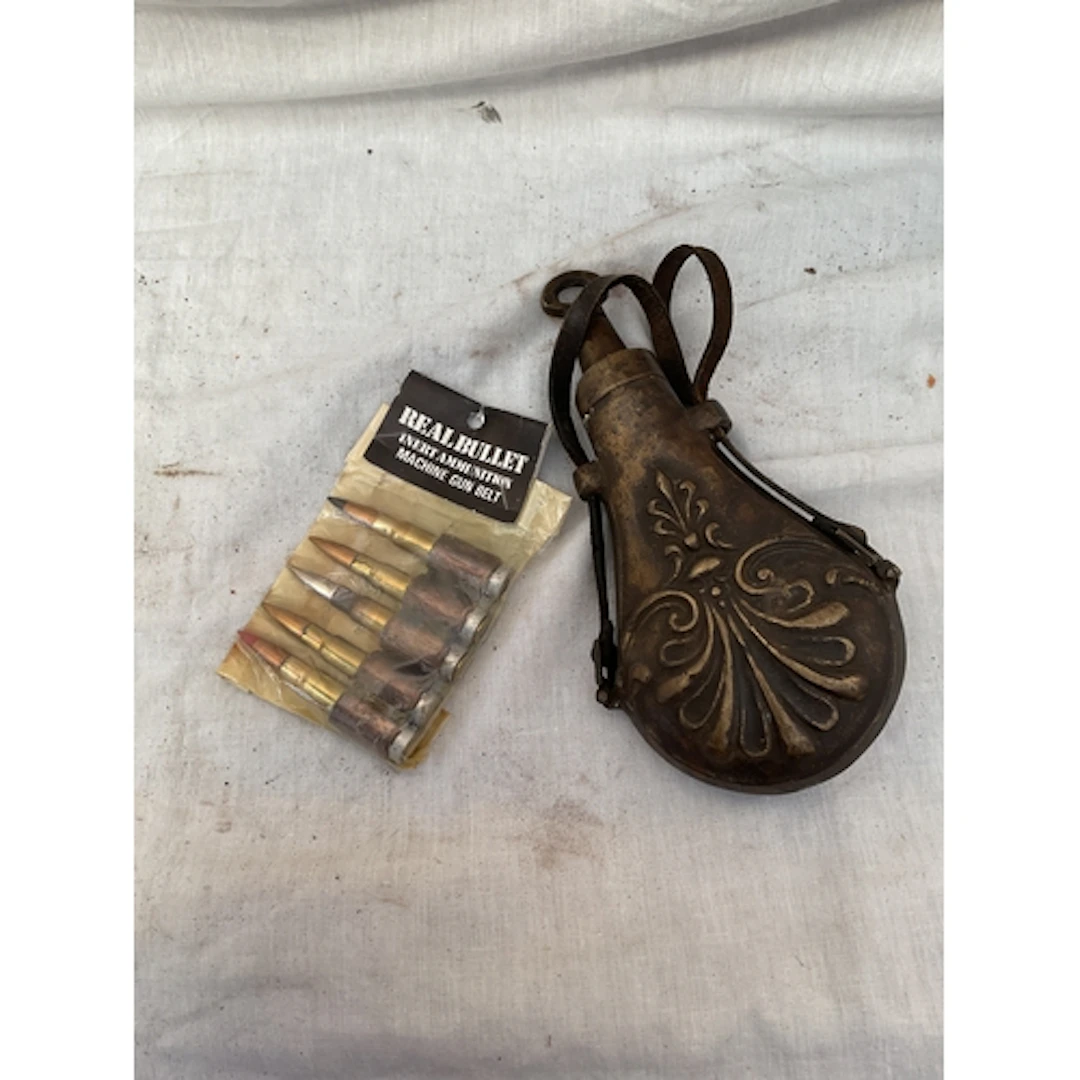 Cast powder flask and inert ammunition.