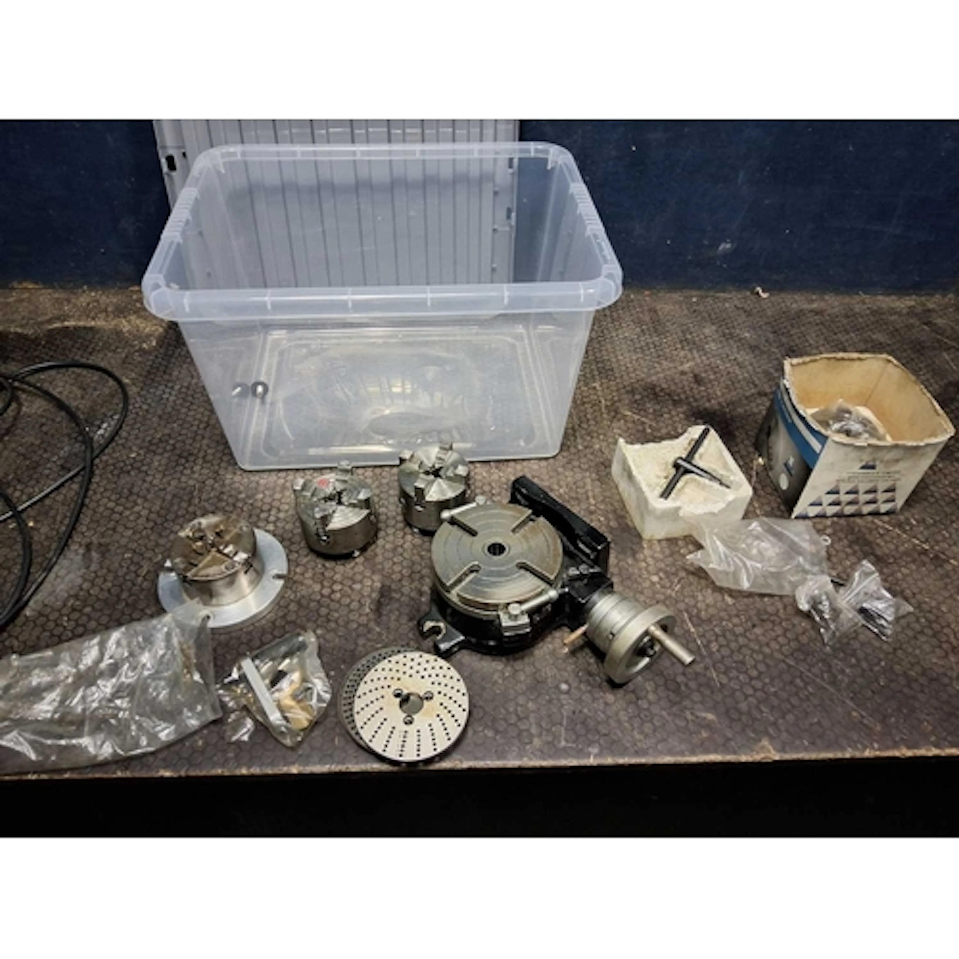 A TRAY CONTAINING LATHE CHUCKS AND TABLES, including three c...