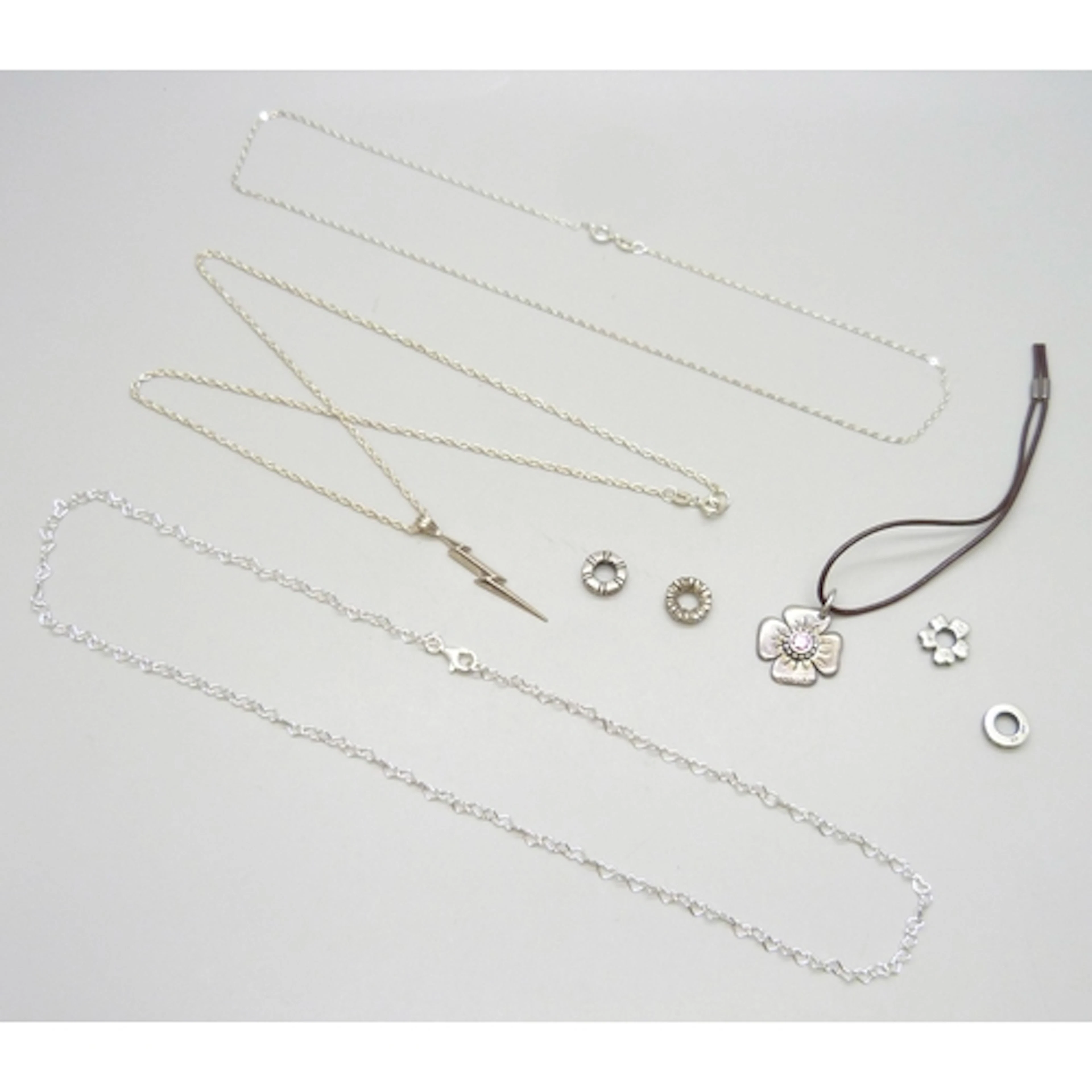 A silver Pandora heart link chain, four Pandora silver charm...