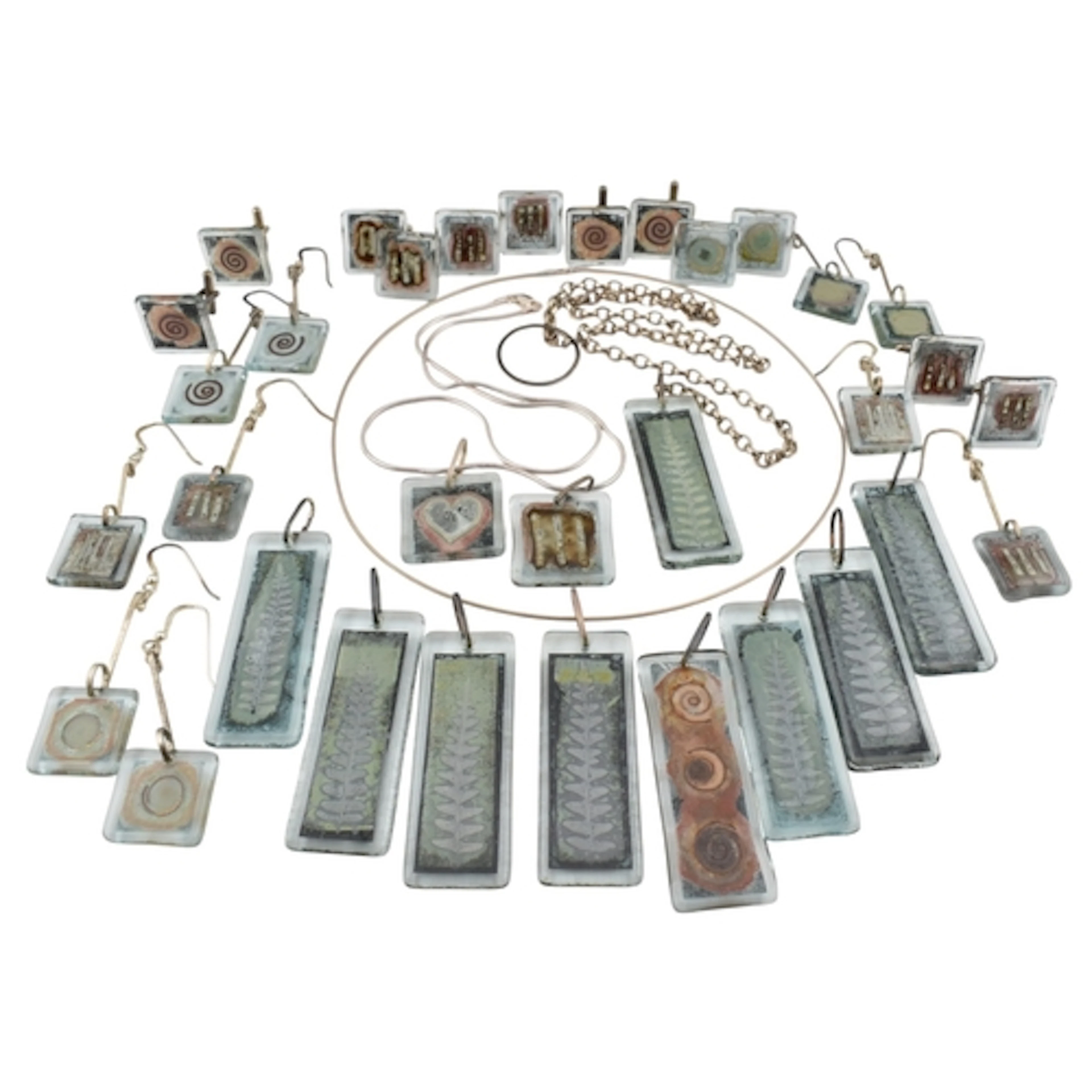 A large collection of artisanal silver and white metal glass...