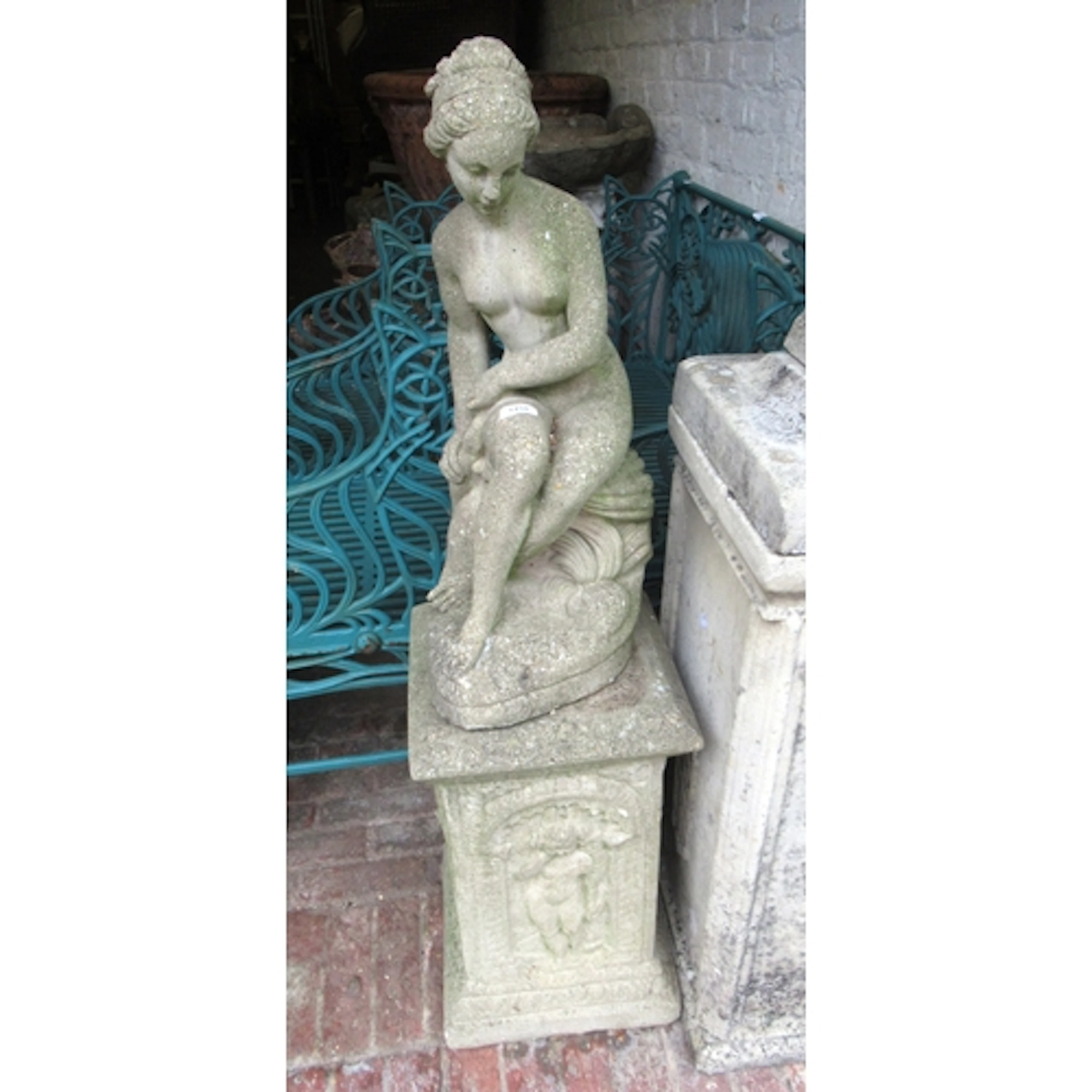 Weathered cast concrete garden figure of a seated classical ...