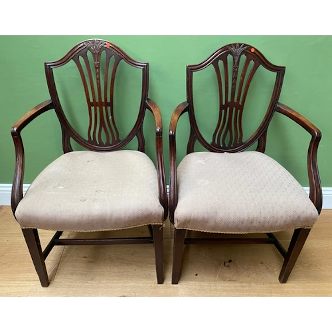 A pair of mahogany open armchair s in Hepplewhite taste, wit...