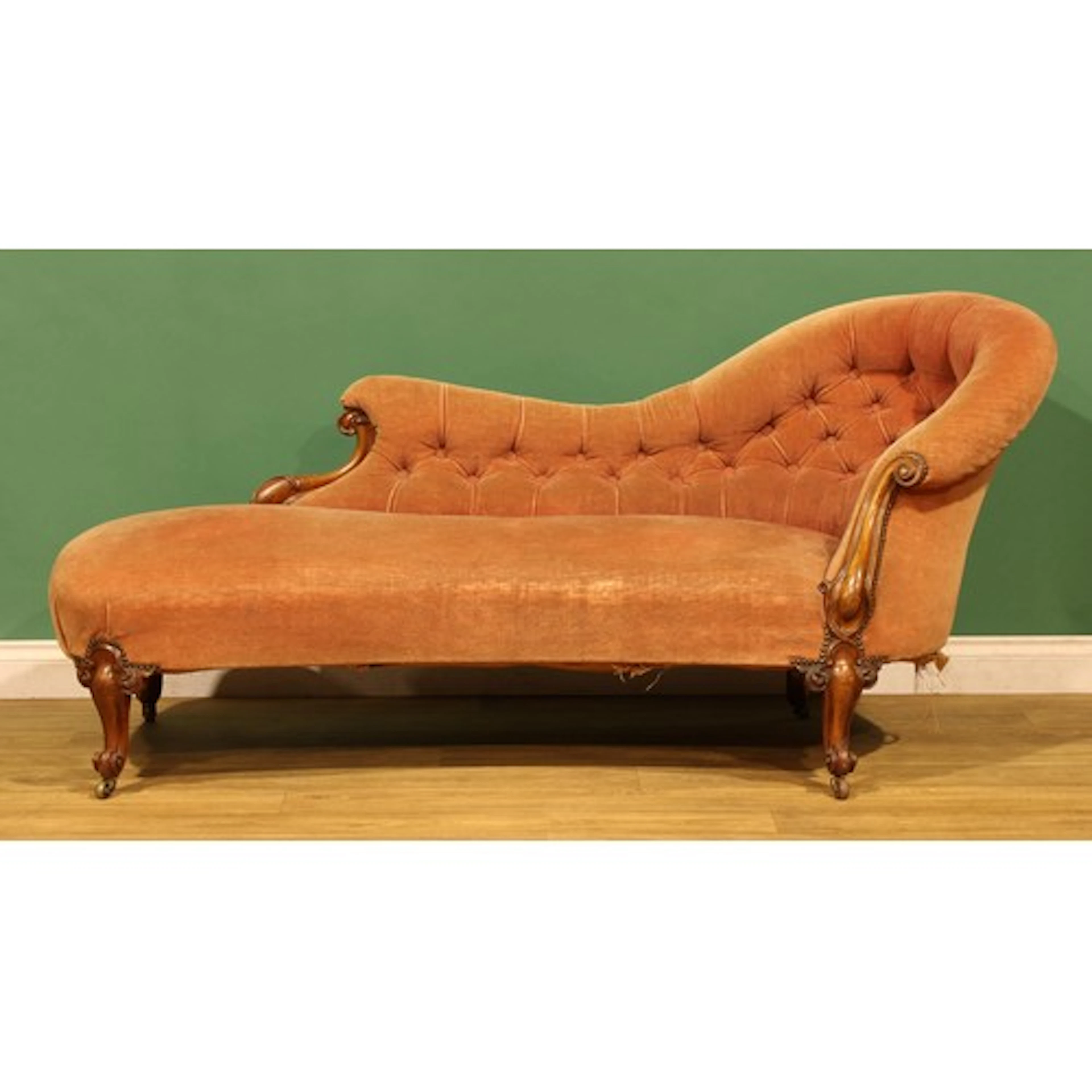 A Victorian rosewood chaise longue, stuffed-over upholstery,...