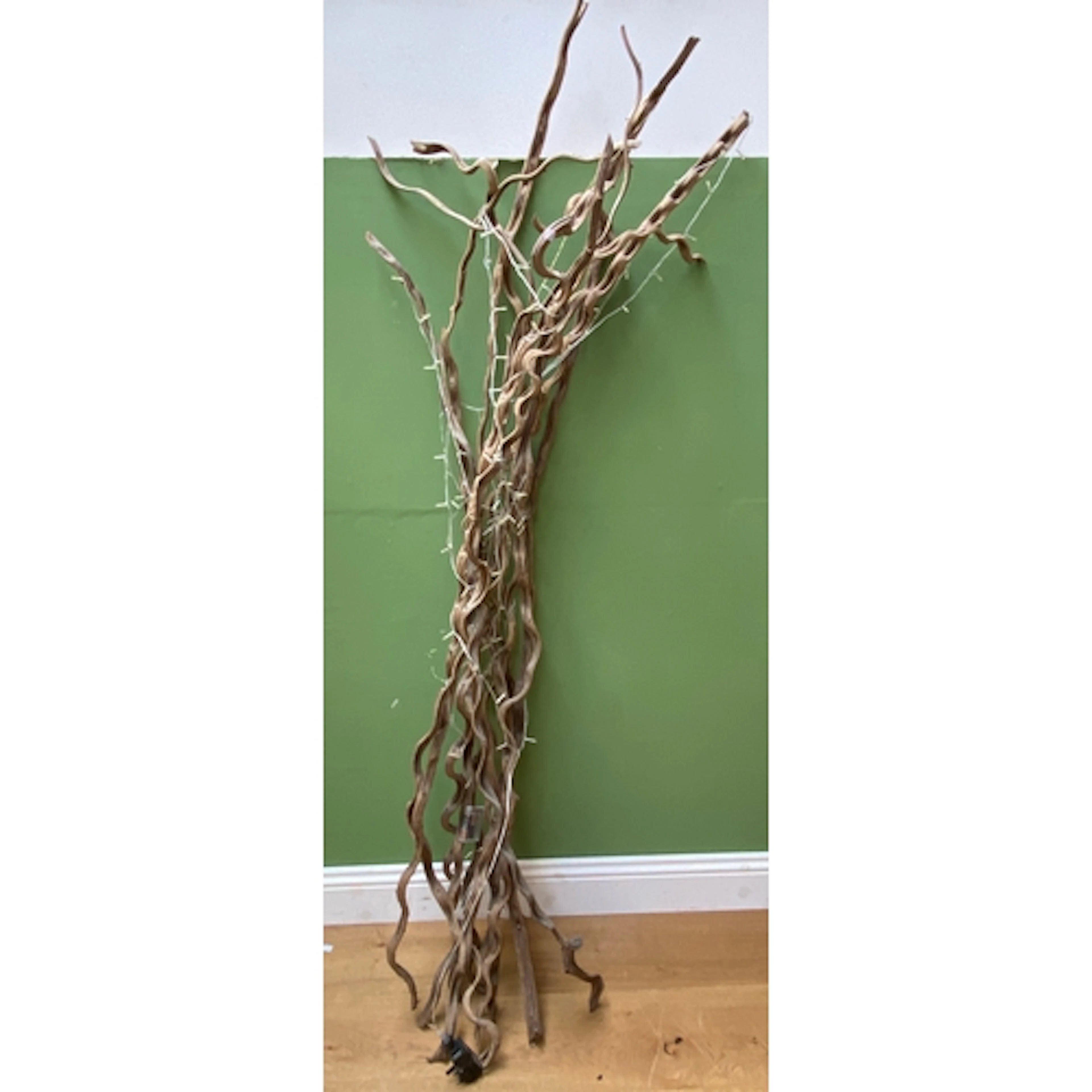 A large decorative dried willow and fairy light sculpture