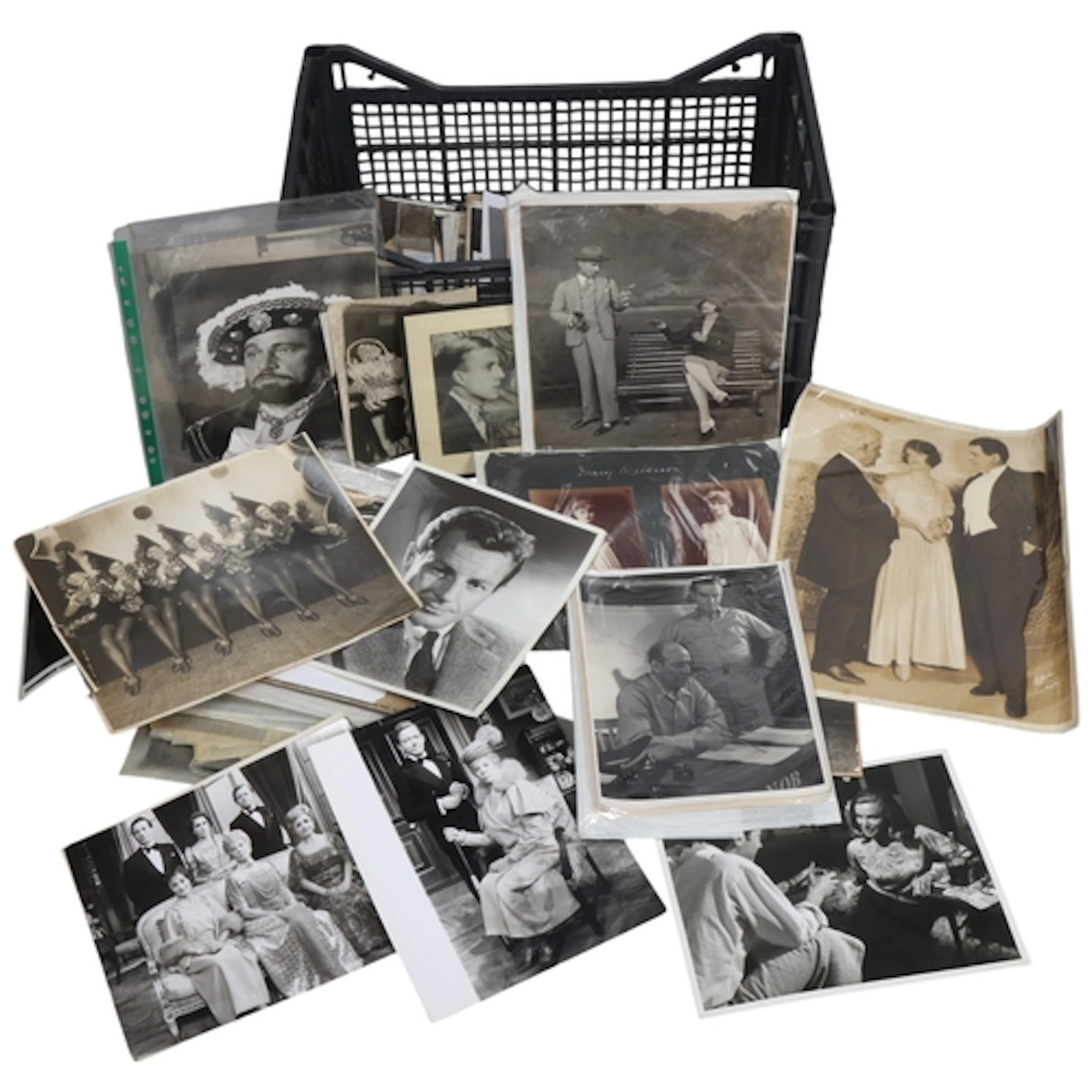 A plastic crate containing a large number of mainly b/w phot...