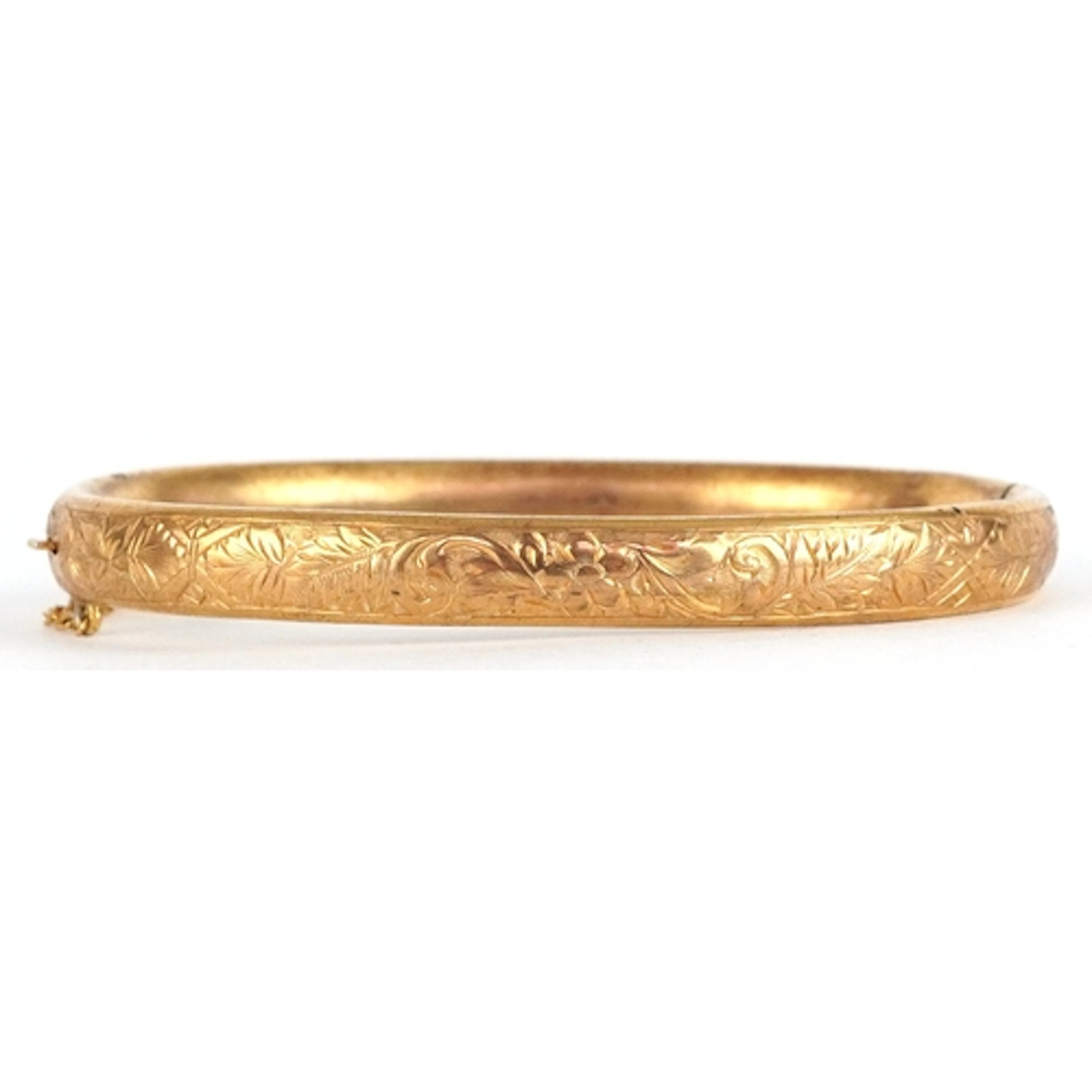 Victorian gilt metal hinged bangle with engraved floral deco...