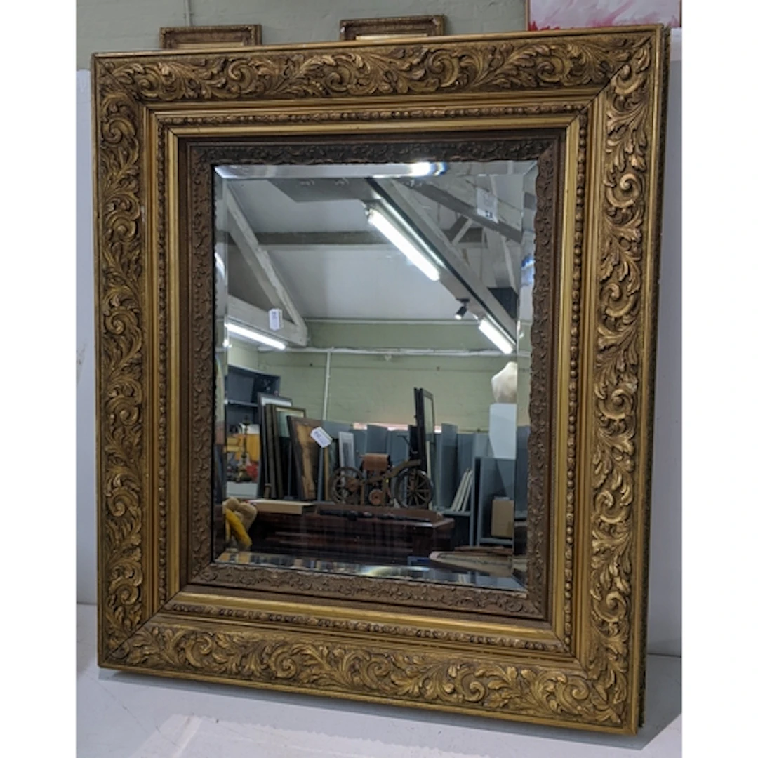 A giltwood rectangular wall mirror, the bevelled plate withi...