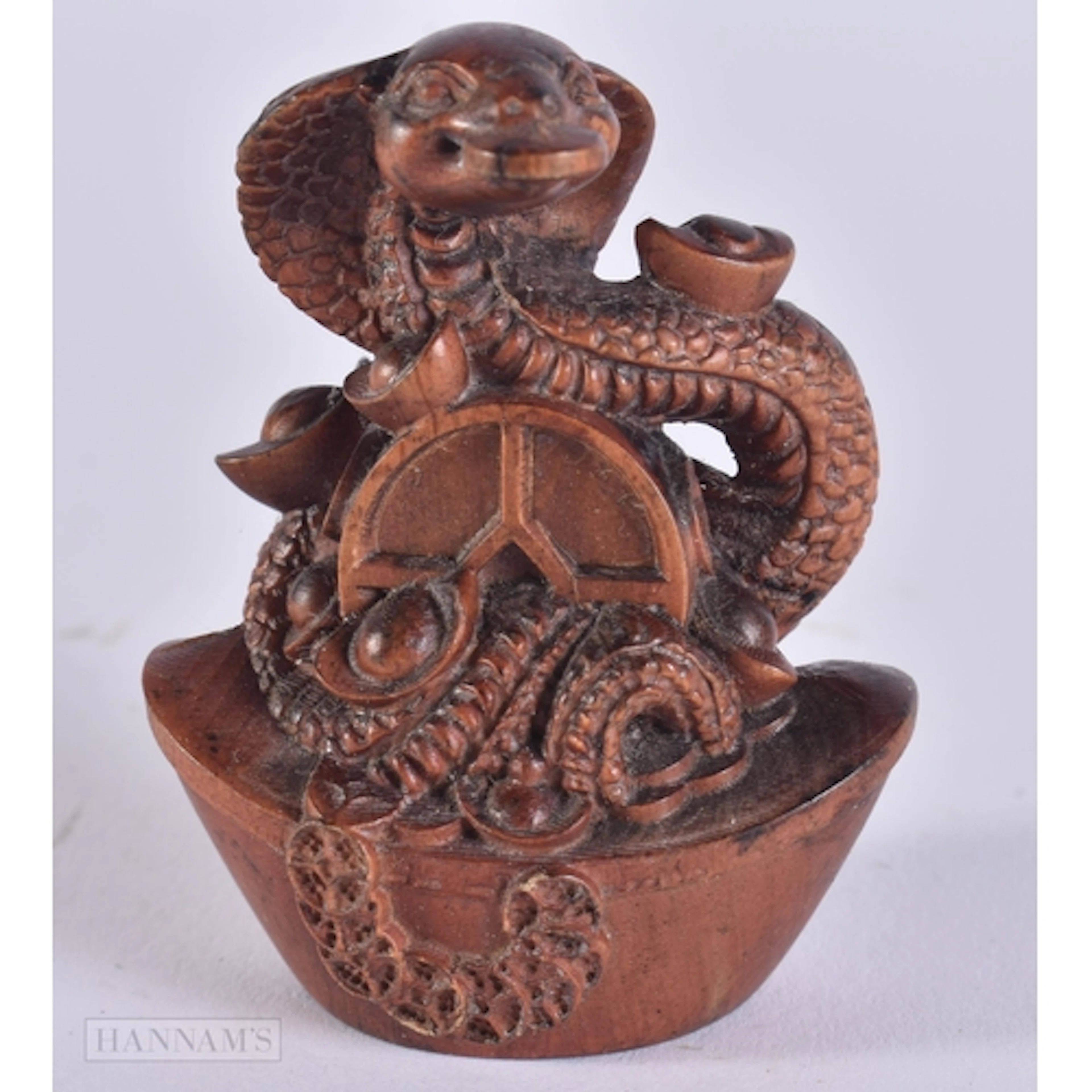 A CARVED WOOD SNAKE. 6 x 4.6 x 3 cm.