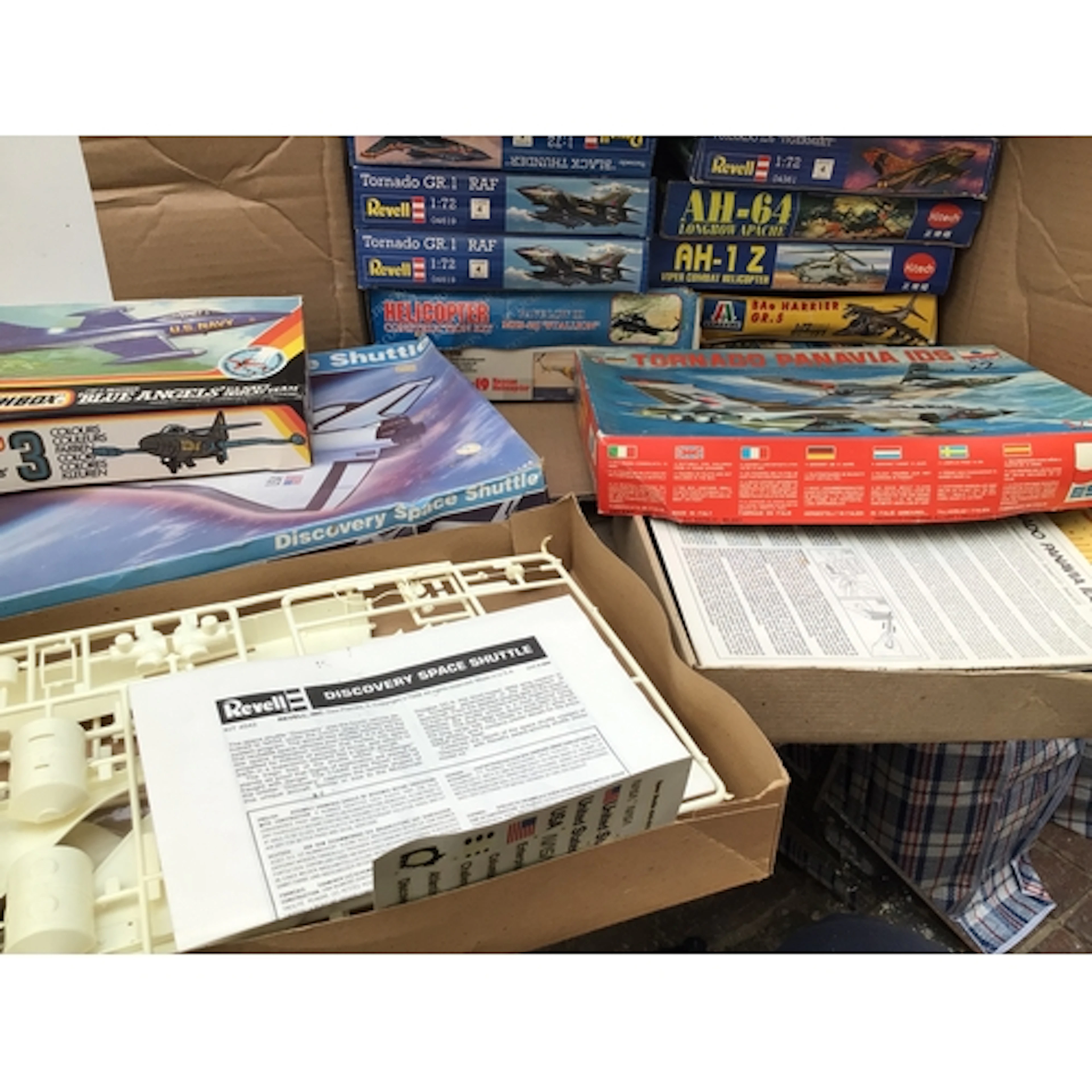 A box containing a collection of boxed model aircraft kits b...