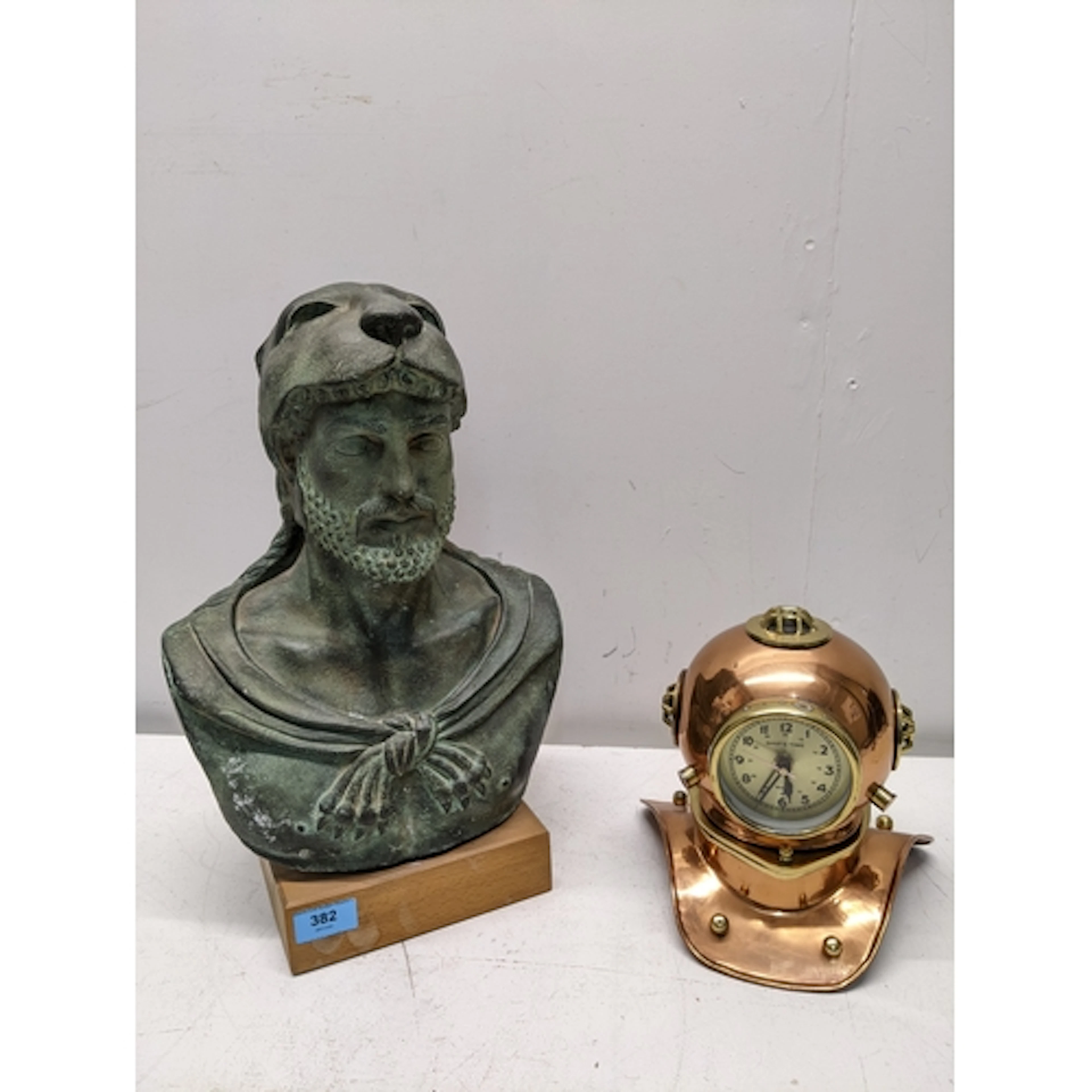 A patinated bronzed ceramic bust of Hercules, mounted on a w...
