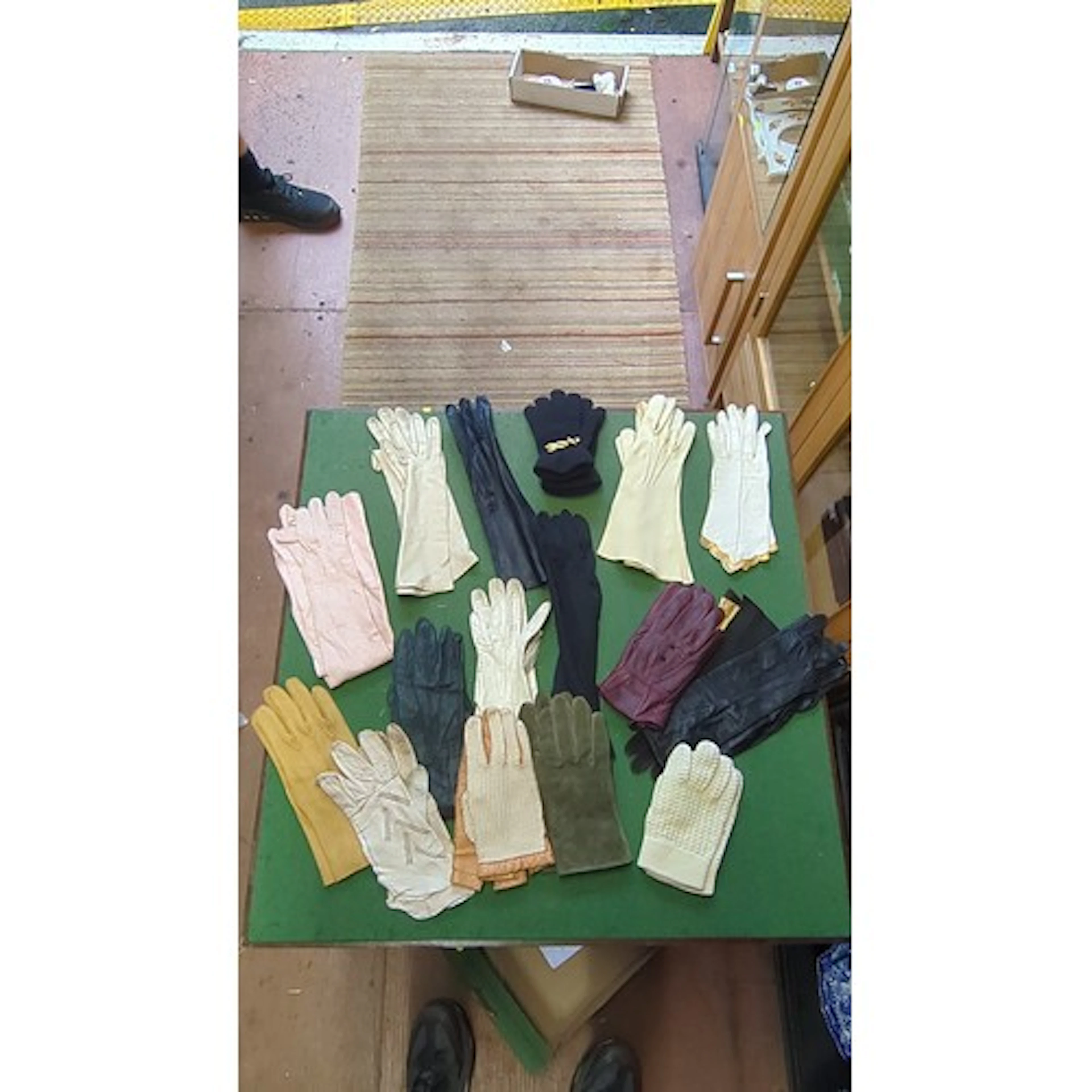 An assortment of ladies’ gloves, primarily leather with knit...