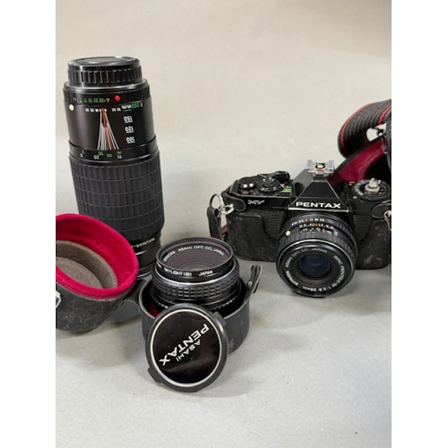Pentax MV camera along with two lenses