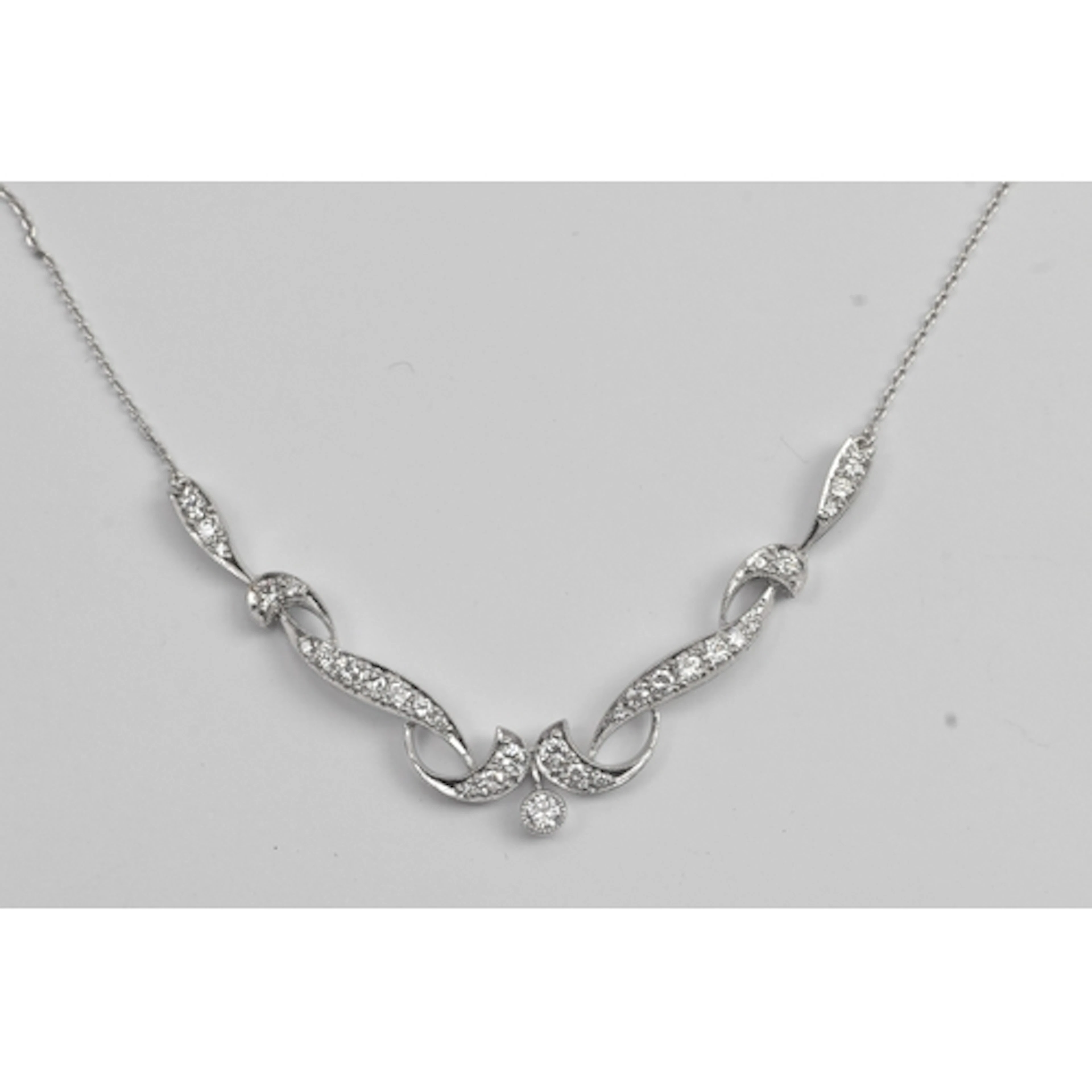 A platinum and diamond festoon necklace with an openwork pan...