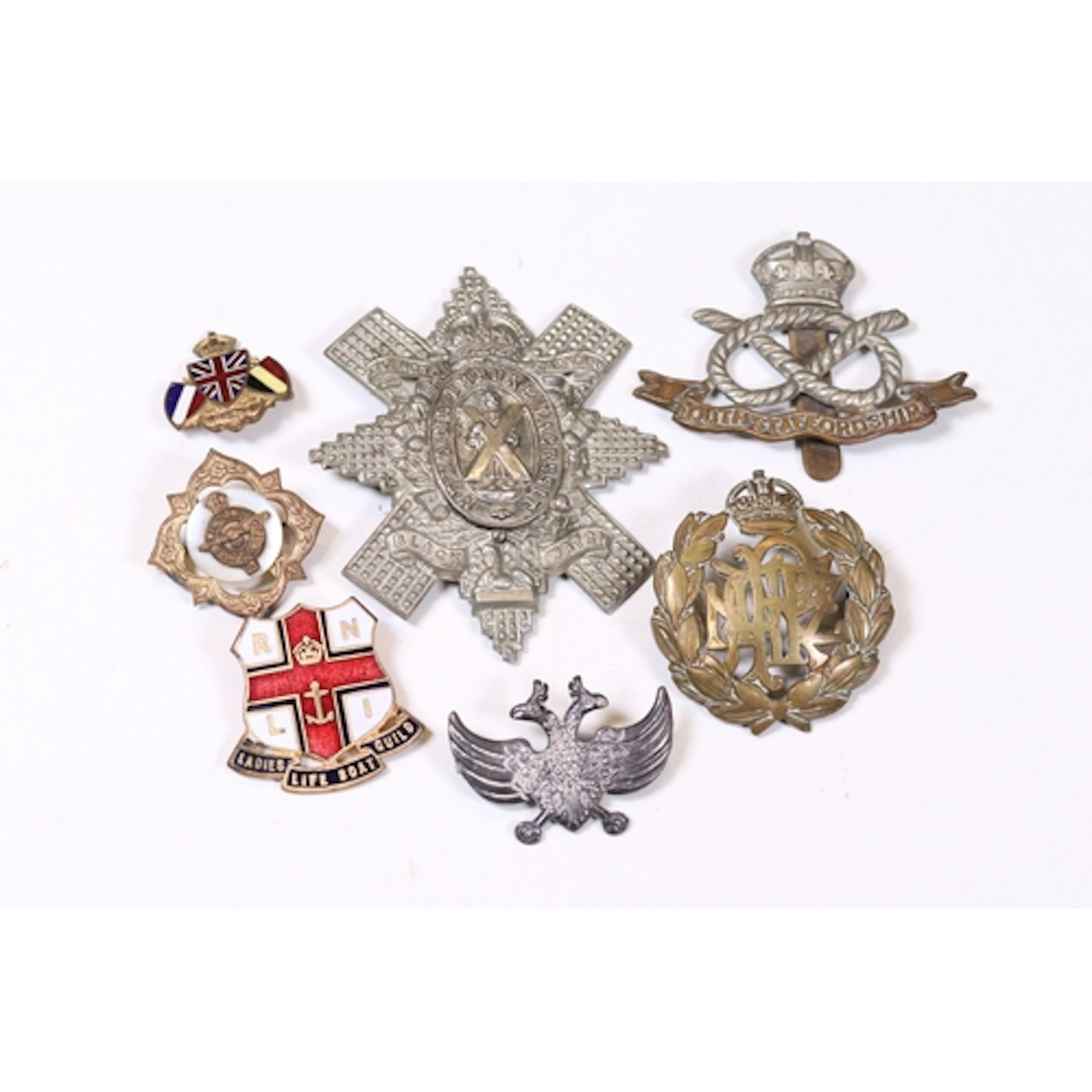 Small selection of military badges including Russian Imperia...