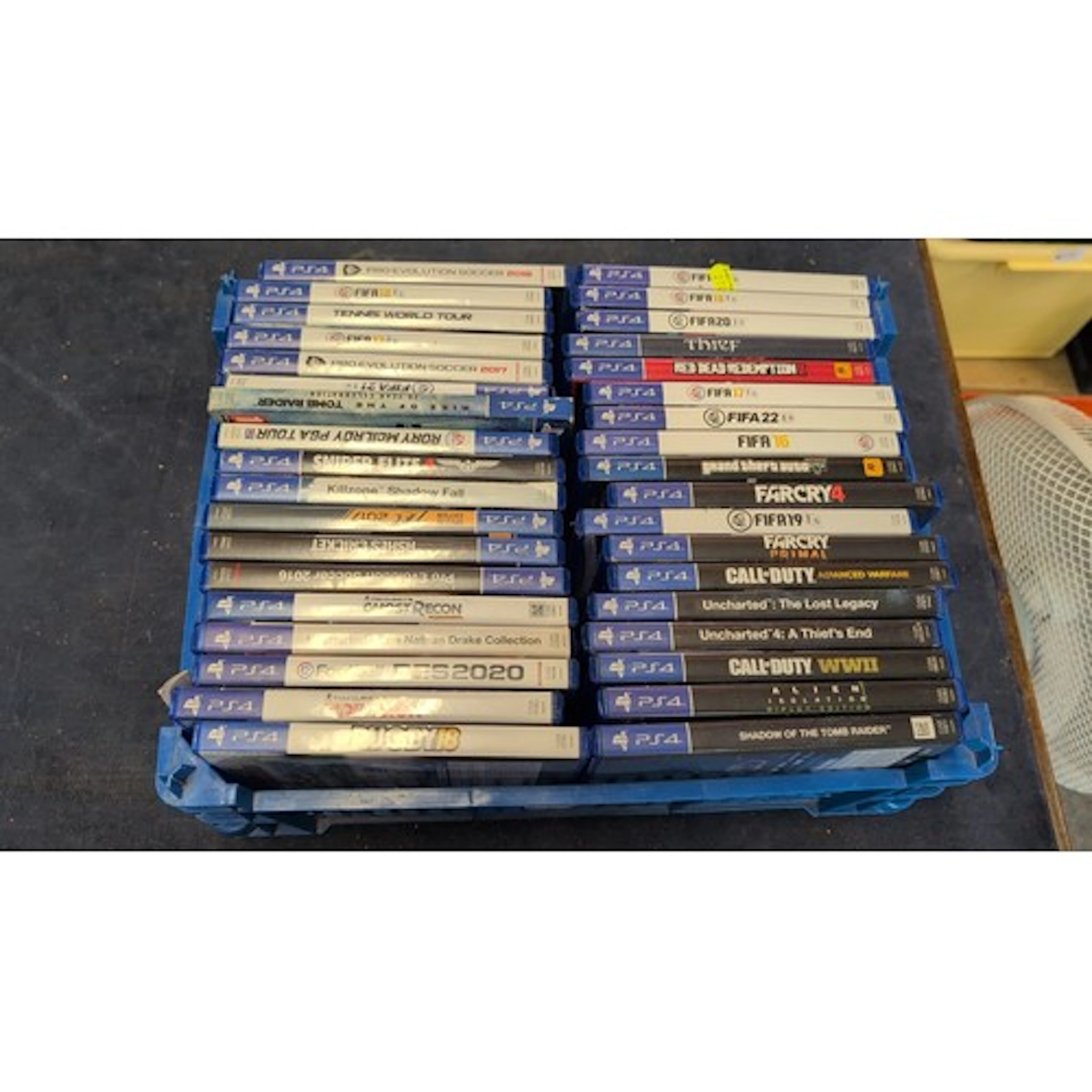 An assortment of PlayStation 4 video game titles in original...