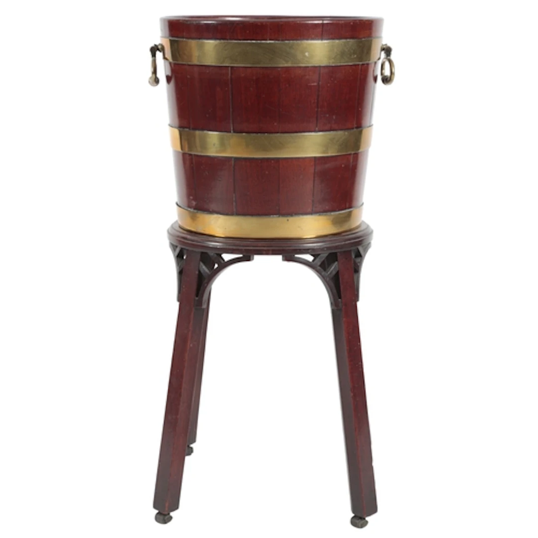 A George III mahogany and brass bound bucket on stand, circa...
