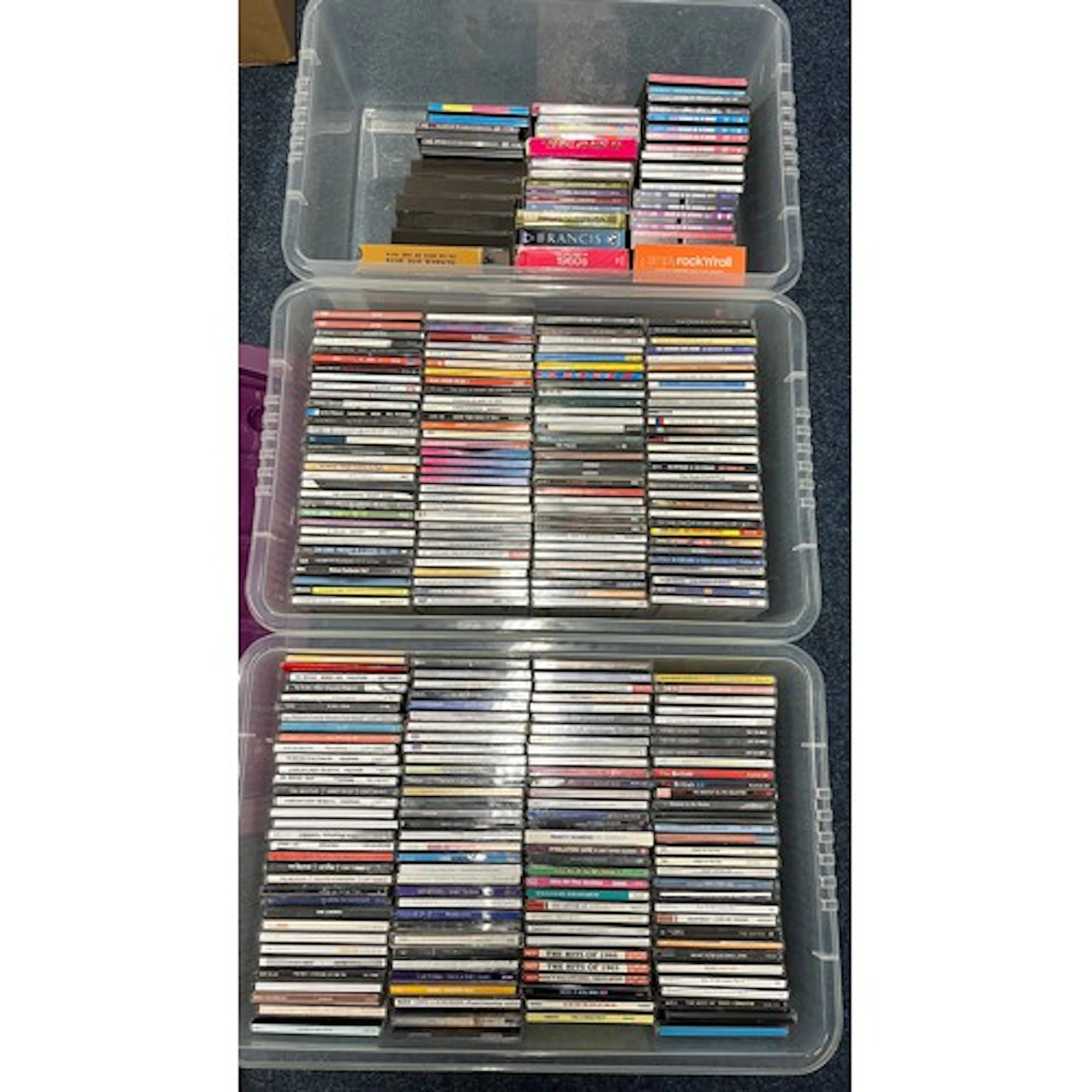 Three boxes containing mixed CDs.