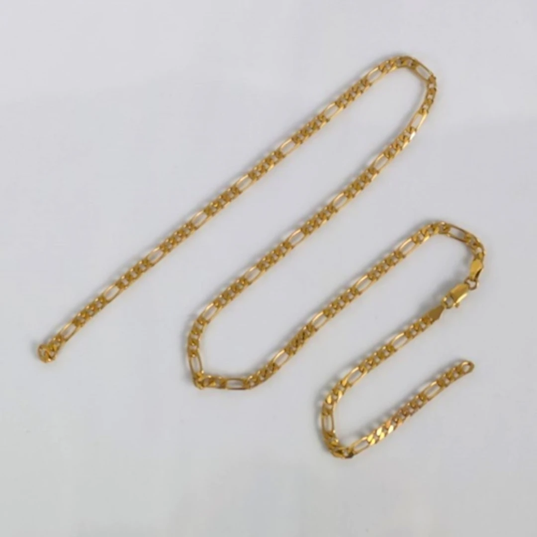 A yellow metal chain, the figaro link chain with lobster fas...