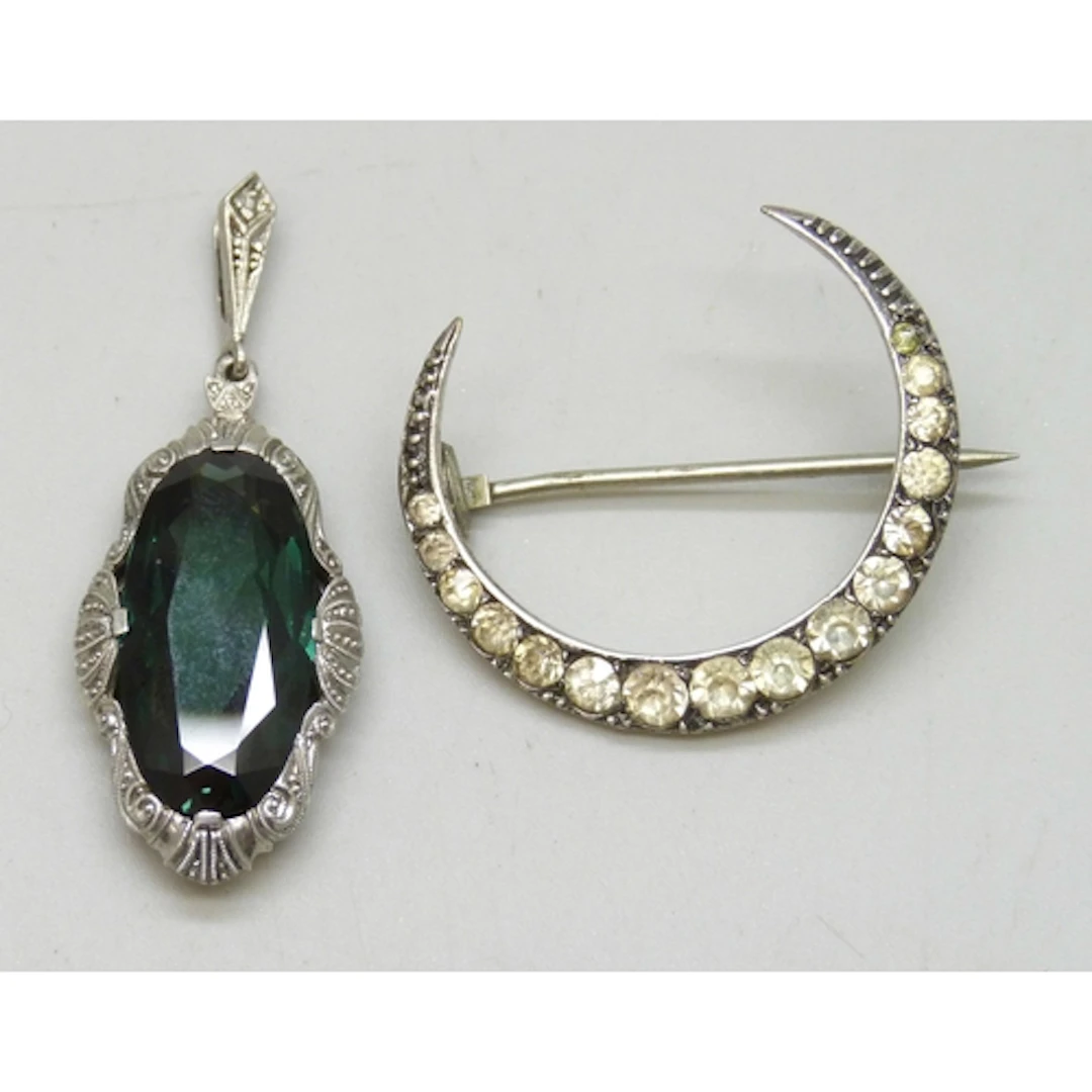 A Victorian white metal paste set crescent brooch, 3cm, an a...