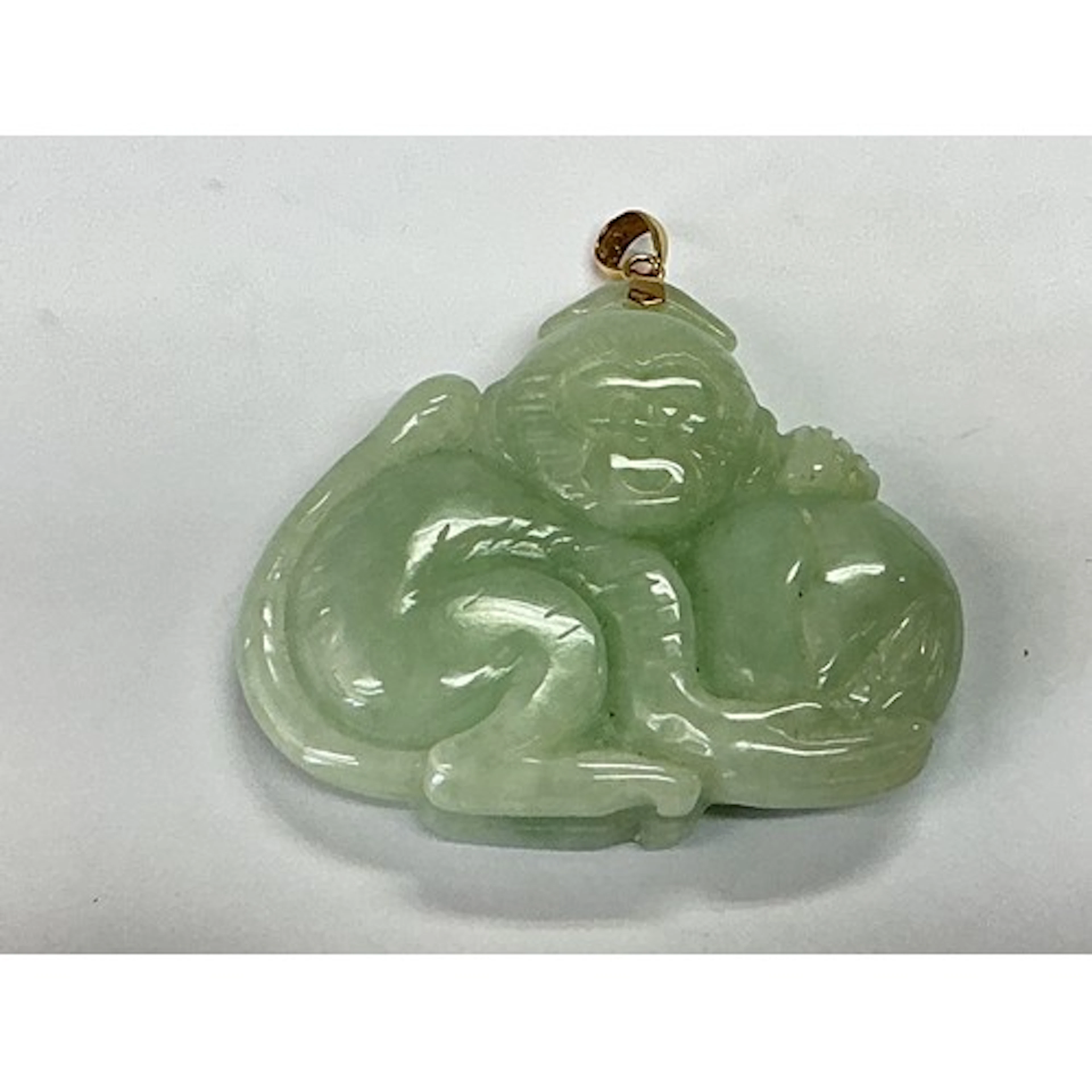 A jade and 14ct gold pendant in the form of a monkey, approx...