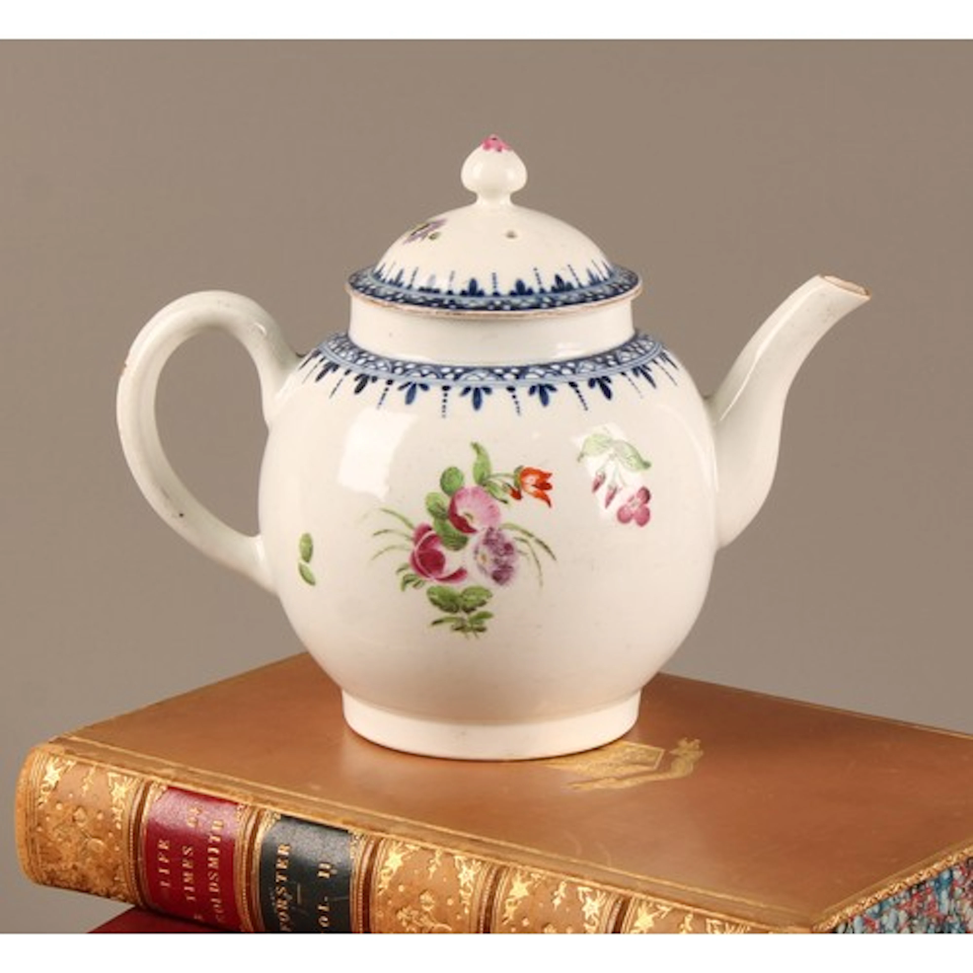 A Worcester globular teapot and cover, painted with colourfu...