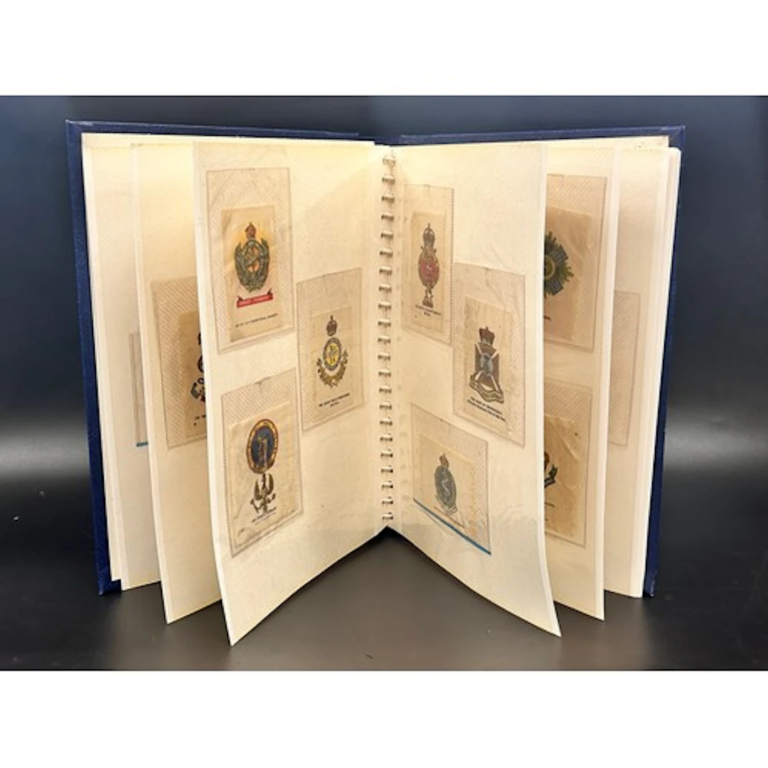 An album of silk cigarette cards; medals, regiments, flags, ...