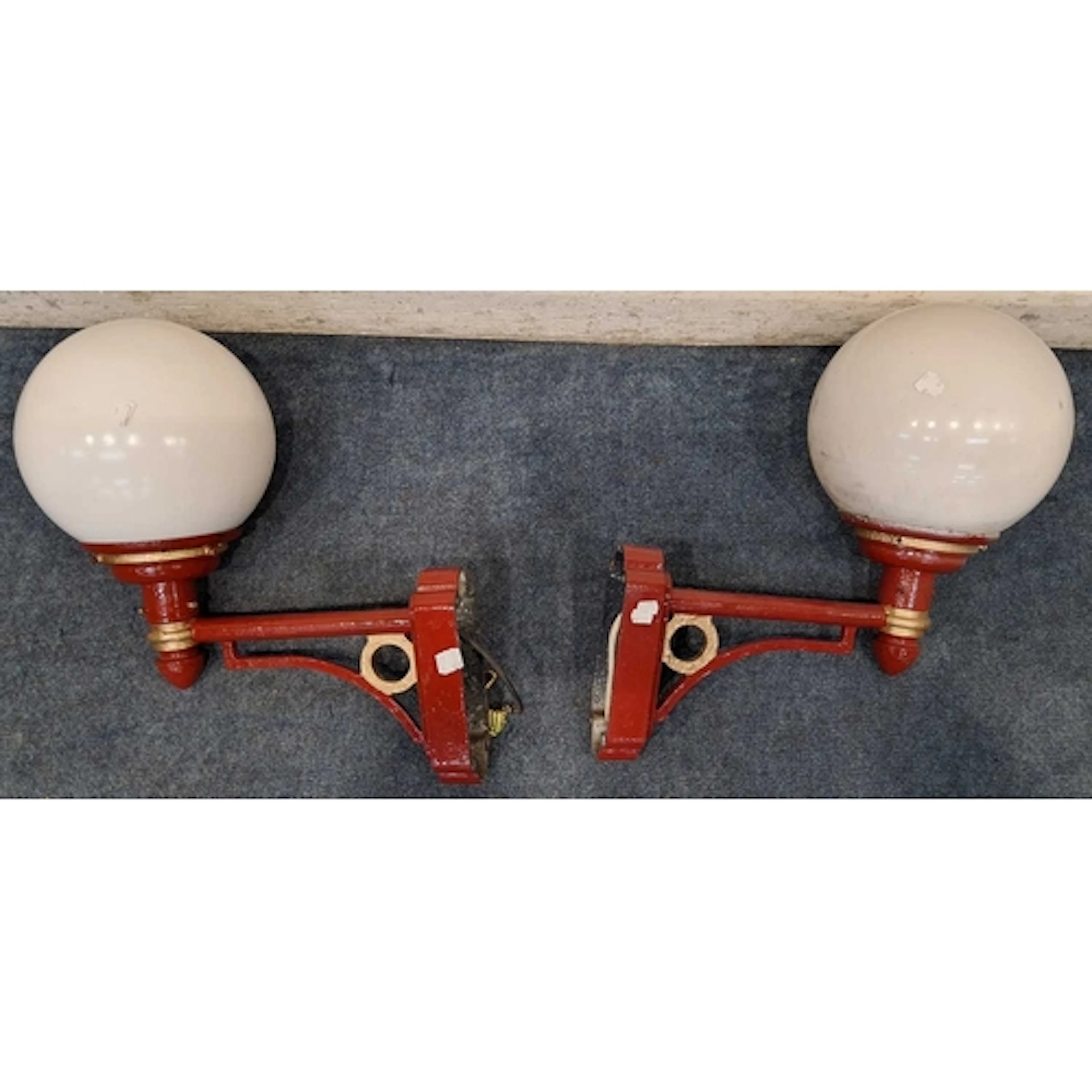 A PAIR OF RED AND GOLD PAINTED CAST ALUMINIUM WALL LIGHTS, w...