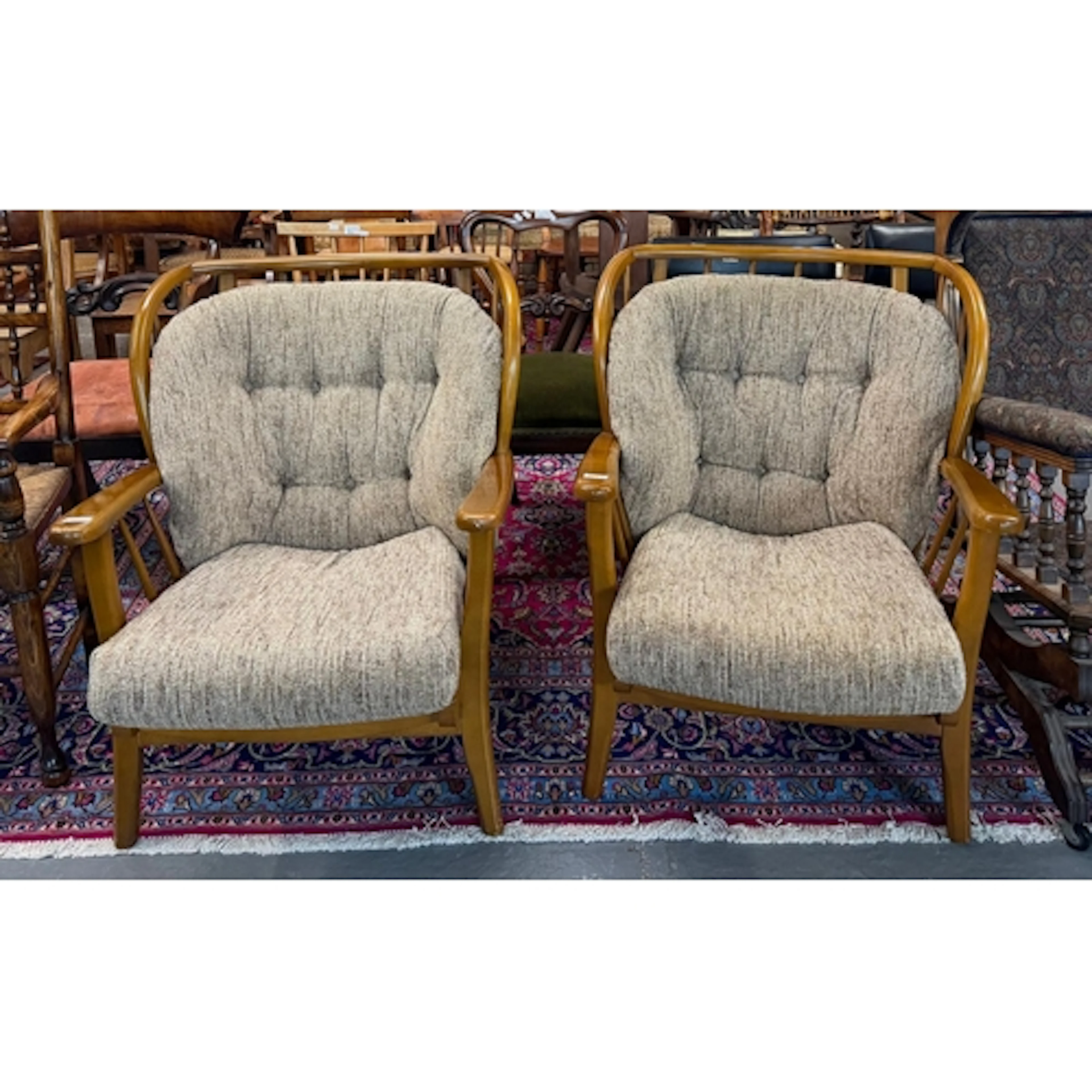 Pair of Ercol stick-backed easy armchairs with loose cushion...