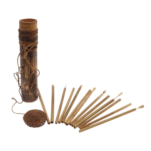 A BORNEO TOLOR BLOWPIPE DART CONTAINER AND DARTS. A bamboo b... | Barnebys