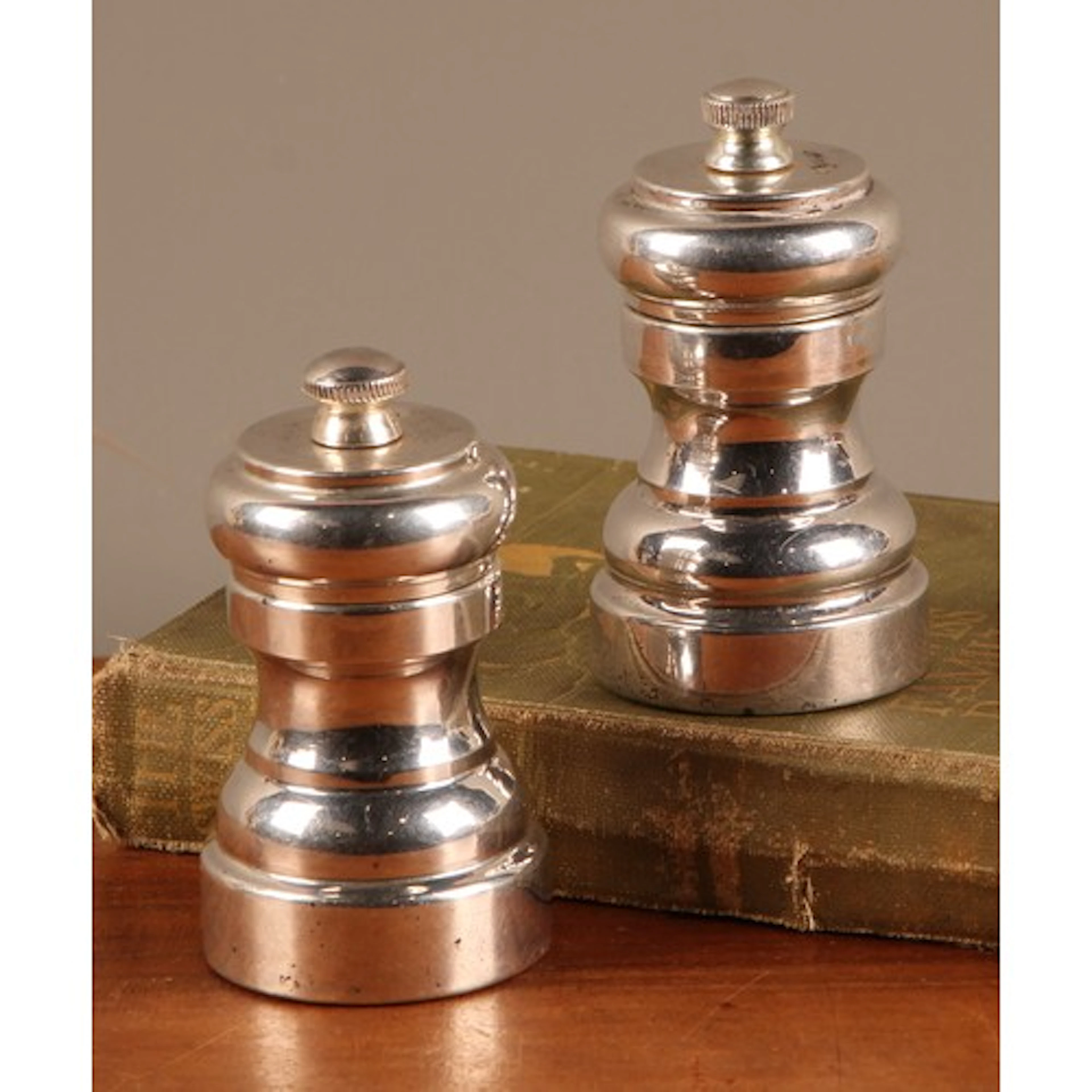 A pair of Elizabeth II silver salt and pepper grinders or mi...