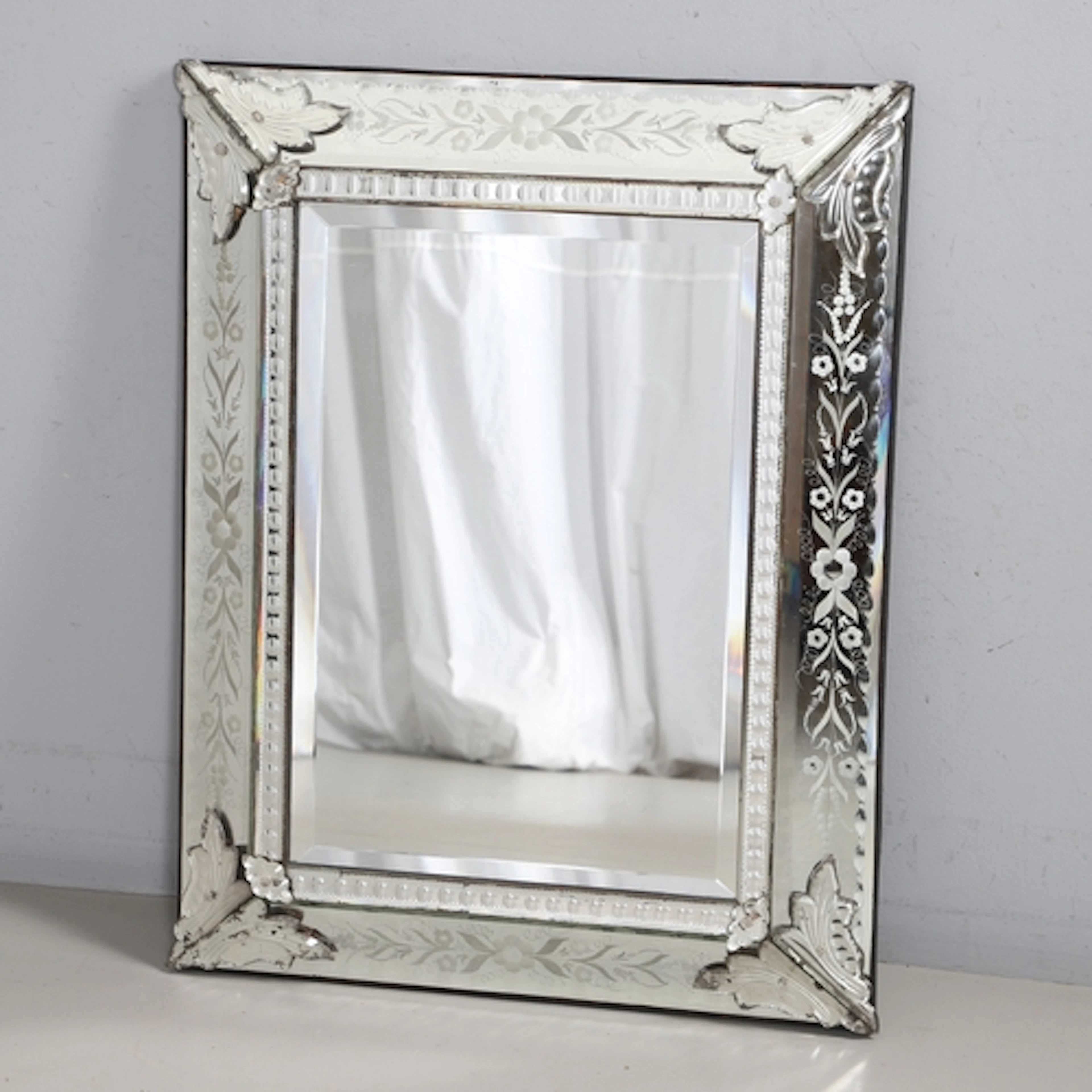 AN EARLY 20TH CENTURY VENETIAN WALL MIRROR. with foliate etc...