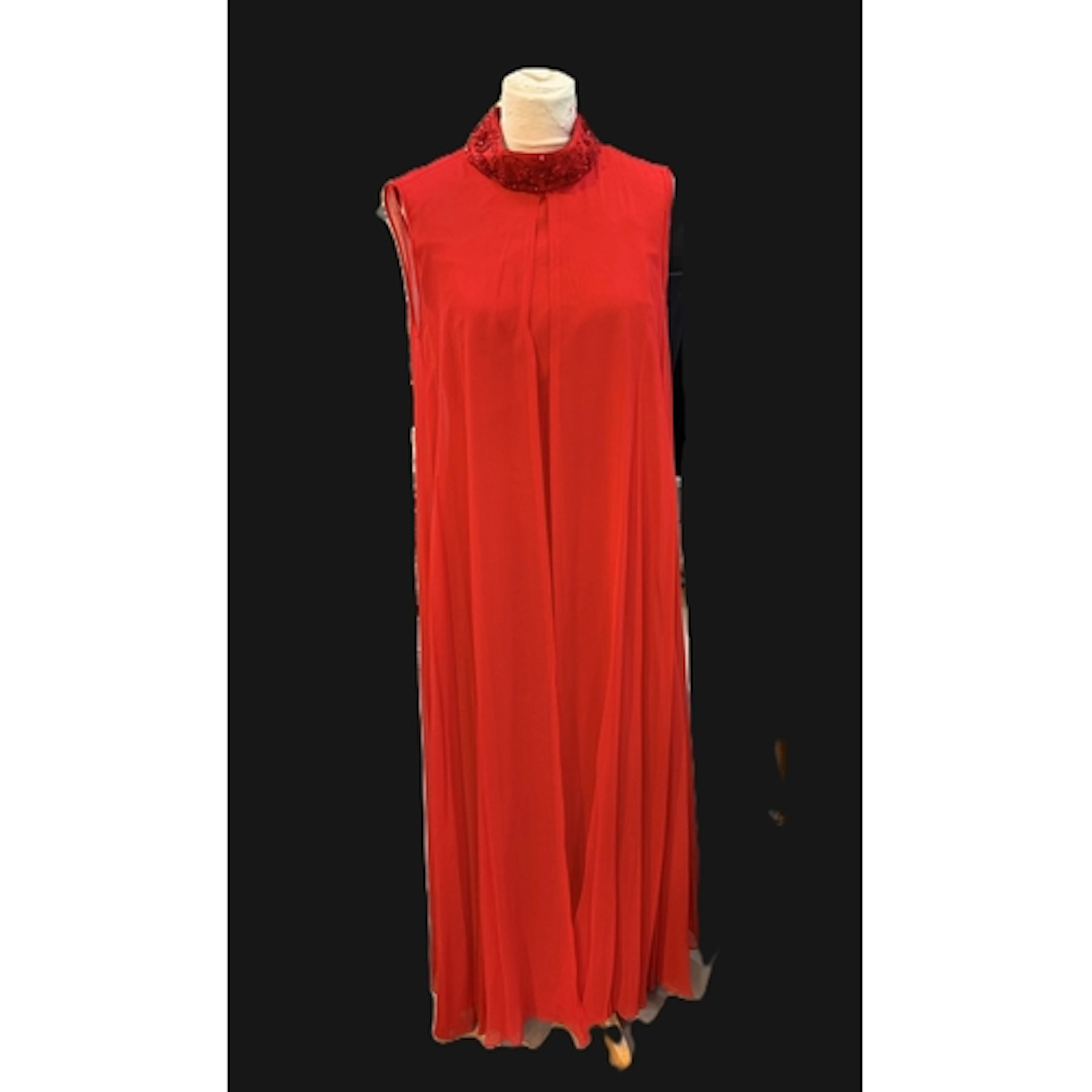 A late 1960's full length elegant evening dress in red lined...
