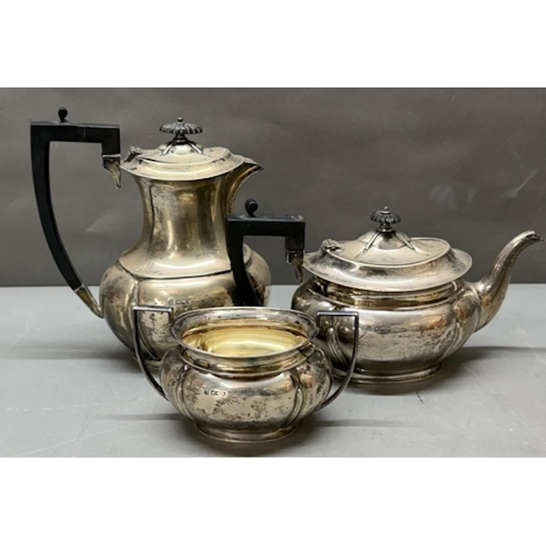 A three piece silver tea service to include teapot, water ju...
