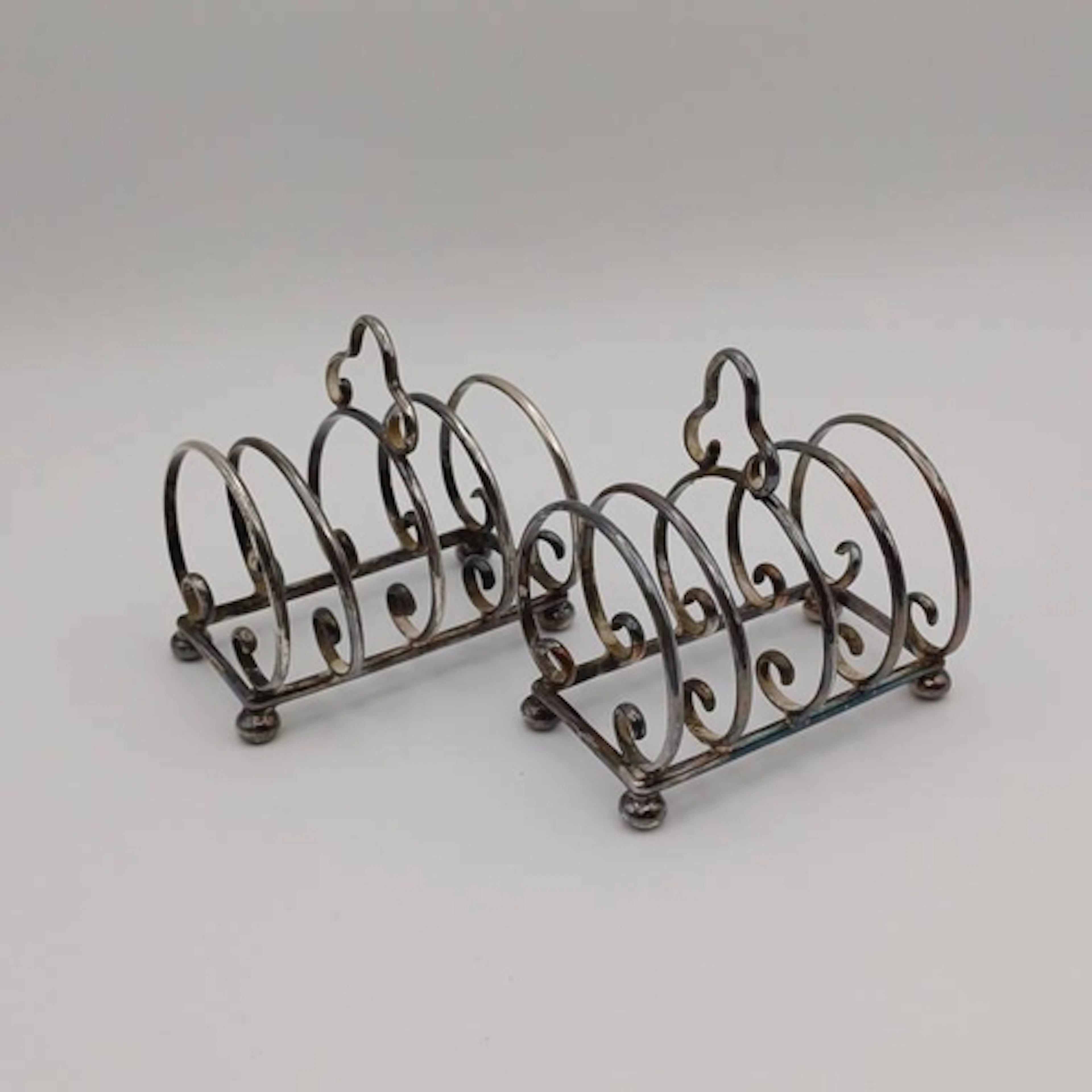 A PAIR OF SILVER 5 BAR TOAST RACKS BY JAMES DIXON & SONS LTD...