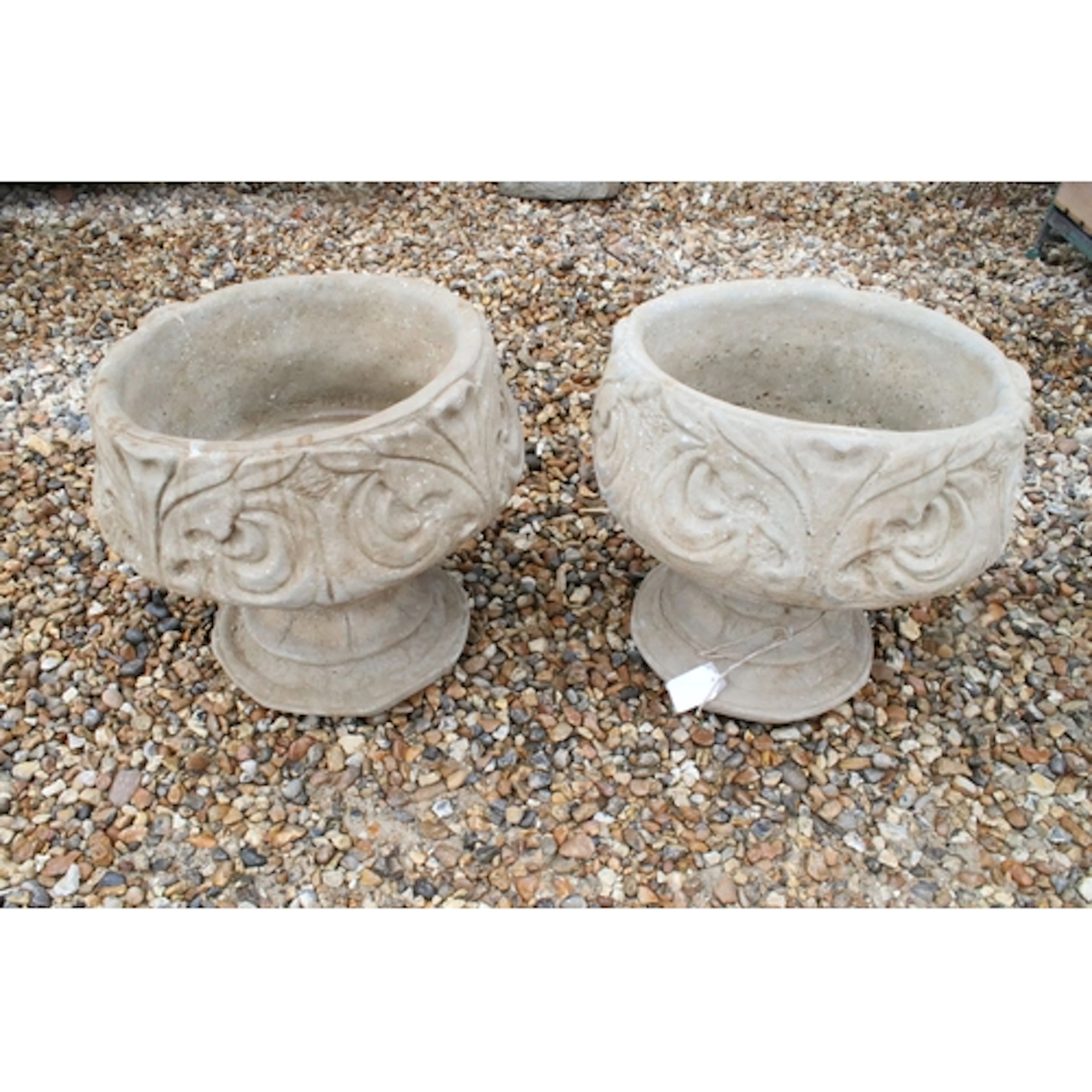 Pair of reconstituted stone garden urns, having fleur-de-lys...