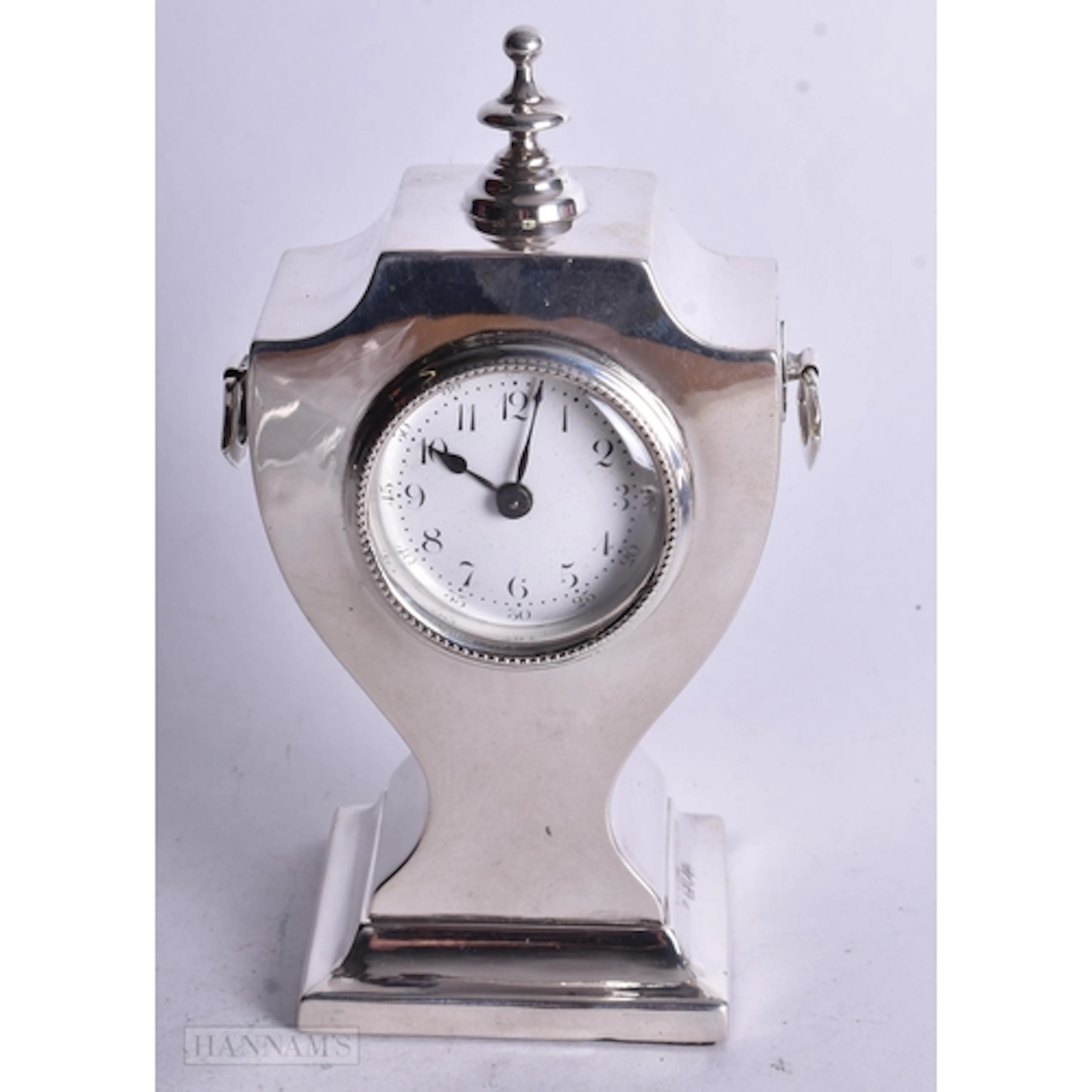 AN ANTIQUE SILVER DESK CLOCK. 431 grams overall. 14 cm high.