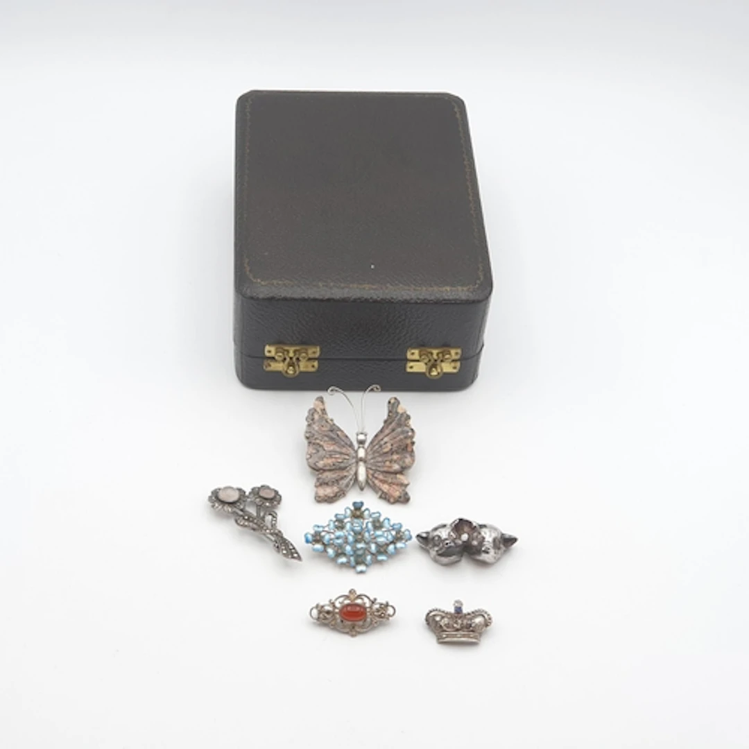 Six various silver Brooches including; double pig 'Tragedy a...