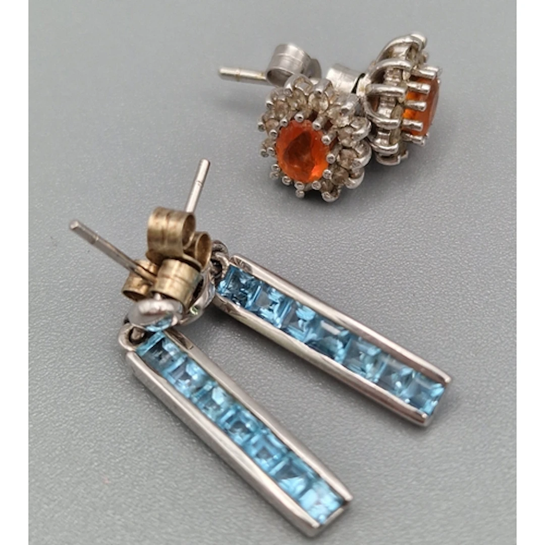 Bag of 9ct white gold earrings set with blue and orange ston...